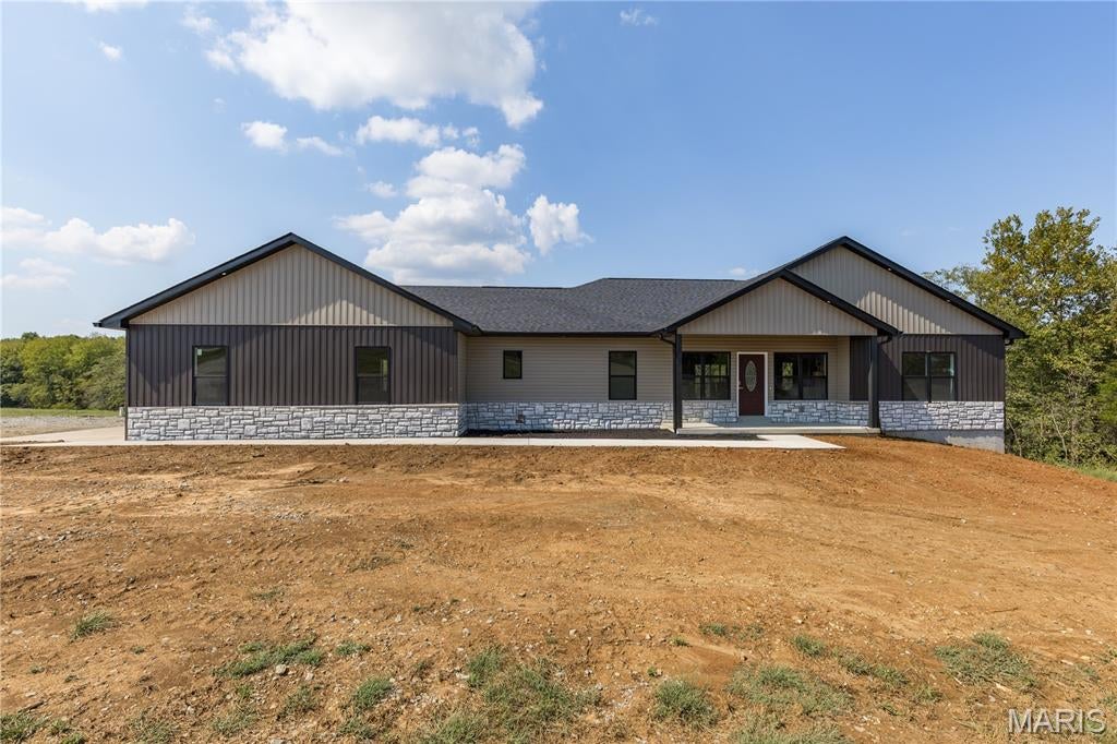 STUNNING NEW CONSTRUCTION ON 3.8 ACRES WITH NO RESTRICTIONS! ? Prepare to be impressed by this gorgeous home featuring nearly 2,000 sq ft of beautifully designed living space and a highly desired open-concept floor plan. From the moment you step inside, the unique color palette, finishes and thoughtful design create a warm, inviting atmosphere that truly stands apart. The welcoming entry features 9’ ceilings and impressive tray ceilings throughout the home. The gourmet kitchen is a showstopper with gorgeous granite countertops, abundant cabinetry, ample workspace and a 8x3 walk-in pantry—perfect for entertaining and everyday living. The spacious primary suite offers a luxurious retreat with a soaking tub, walk-in shower, dual vanities and an amazing 9’ x 7’ walk-in closet complete with a laundry chute! Two additional spacious bedrooms, a full bath and a convenient half bath for guests complete the main level. The oversized 30’ x 26’ attached 3-car garage provides plenty of room for vehicles, toys and storage. A full unfinished walk-out basement offers endless possibilities for future living space, a fourth bedroom, recreation room or whatever your needs may be. The home has upgraded whole house well water filtration system  and 2X6 exterior walls with R-19 insulation. Outside, enjoy the covered deck overlooking the private wooded backdrop, open acreage, small creek and beautiful St. Francis County countryside. With 3.8 acres and NO restrictions, there is room for a mini farm, pasture, gardens or simply enjoying your own piece of country. Located just 10 miles from downtown Farmington and approximately 8 miles to Hwy 67 in the Bonne Terre area, this property offers the best of country living while keeping everyday amenities close by. New construction, gorgeous design, acreage and no restrictions—this is the country lifestyle you’ve been waiting for!