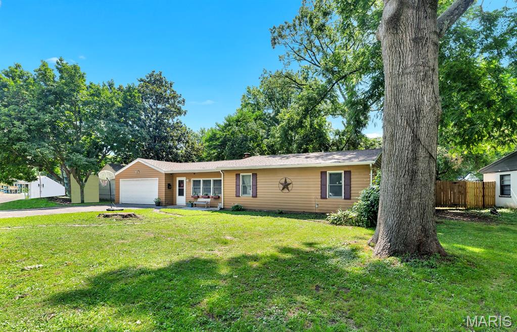 GREAT HOUSE - GREAT PRICE!  This beautiful 3 bedroom/1 bath property, flooded with natural light, is move-in ready. Your first step into the home impresses with a large, bright living area featuring a striking, wood-burning fireplace. And, it works. There is plenty of room for family and friends to gather to make memories and/or the new owner may create zones for games, a reading corner, or displays.  It's a little hot now for that fireplace, but you will appreciate the ambiance when Winter rolls around. A hallway leads to the three bedrooms and a really nice bathroom that includes a generously-sized closet area for storage. Take a few more steps to the breakfast room and striking updated kitchen.  (The stainless steel refrigerator will stay.)  Another space off the kitchen with access to the back yard serves as a utility and laundry room with new flooring. The breakfast nook leads to a spacious, newer, screened porch offering bonus living space with a view and entry to the wide back yard. The outside yard showcases a large deck for entertaining and a yard already filled with fun for kids. The space is fenced, but the fences belong to the neighbors.  Keyless entry. Smart thermostatt. Don't miss the oversized, attached two-car garage!

Shopping, highways, parks, and public transportation are conveniently nearby. The home is only blocks away from two major thoroughfares offering restaurants, bars, and the popular Ferguson Farmer's Market. 

Showings require preapproved buyers, only.