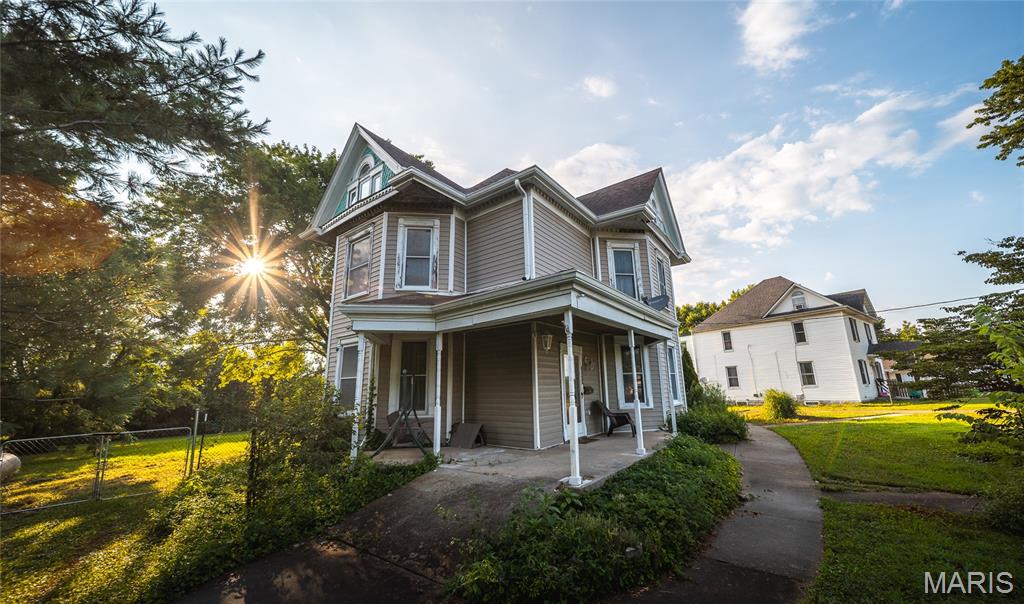 Step back in time without sacrificing modern comfort in this beautifully preserved 1880 Victorian home situated on 0.82 acres in the heart of Owensville. Rich with historic charm and timeless architectural details, this spacious 4-bedroom, 3-bath residence offers a rare opportunity to own a piece of local history while enjoying thoughtful updates for today's lifestyle.

From the moment you enter, you'll be captivated by the character throughout, including original pocket and panel doors, vintage hardware, and a blend of hardwood, laminate, and carpet flooring that complements the home's classic appeal. Multiple living spaces, including a formal dining room, office, mudroom, and laundry room on the main level, provide flexibility for everyday living, entertaining, or working from home.

The second and third floors offer generous bedroom space, including a private upper-level suite, while the home's unique dumbwaiter shaft—currently not in service—offers the opportunity to restore a distinctive historic feature. Enjoy peaceful mornings on the rear decks located on both the first and second floors, overlooking the fenced backyard.

Recent improvements include new gutters, both furnaces replaced, a new 2025 dishwasher, and a new water heater to be installed, providing added peace of mind. The stone foundation has been professionally reinforced by Foundation Recovery Systems and includes a transferable warranty, along with new interior basement stairs. A detached shed offers additional storage and has the potential to reconnect power.

Historic elegance, modern updates, and endless character come together to make this one-of-a-kind Victorian truly special. Don't miss your chance to own a stunning piece of Owensville history—schedule your private showing today and experience its timeless beauty for yourself!