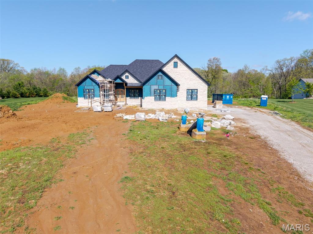 A rare opportunity to secure a generational family estate currently under construction on just over two pristine acres, where enduring craftsmanship, thoughtful design, and timeless elegance are coming together to create a home meant to be cherished for decades. Construction is underway with anticipated completion this Spring, offering the ideal balance of certainty and customization.

This five-bedroom ranch has been intentionally designed for both today and tomorrow, featuring a refined split-bedroom floor plan and an expansive open-concept layout that effortlessly supports everyday living, family gatherings, and milestone celebrations alike. A three-car side-entry garage enhances the home's stately presence while preserving its architectural balance.

At the heart of the home, a chef-inspired kitchen is being crafted to flow seamlessly into the dining and family rooms, creating a welcoming central gathering space. Just beyond, a covered rear porch extends the home's livability and provides a peaceful setting to enjoy the surrounding acreage.

The primary suite is envisioned as a private retreat, showcasing a spa-inspired bath with a luxury wet room, designer finishes, and an impressive walk-in closet. A generous walk-in pantry and thoughtful circulation throughout the home reflect the elevated functionality expected in a truly custom residence.

The opposite wing will feature two spacious bedrooms connected by a beautifully appointed bath, a layout thoughtfully echoed in the finished lower level. Downstairs, the basement expands the home's versatility with substantial storage, a secure safe room, a stylish bar area, and an expansive secondary living space—ideal for entertaining, accommodating guests, or creating multi-generational flexibility.

Perhaps most compelling is the opportunity—while construction remains underway—to collaborate directly with the design team at C&T Homes. Buyers will have the ability to thoughtfully personalize finishes, select details, and make meaningful design choices that align with their lifestyle and long-term vision.

Homes of this caliber, setting, and craftsmanship—combined with the ability to influence the final design—are exceptionally rare. Secure your place, shape the finishing touches, and begin building a legacy designed to endure for generations.