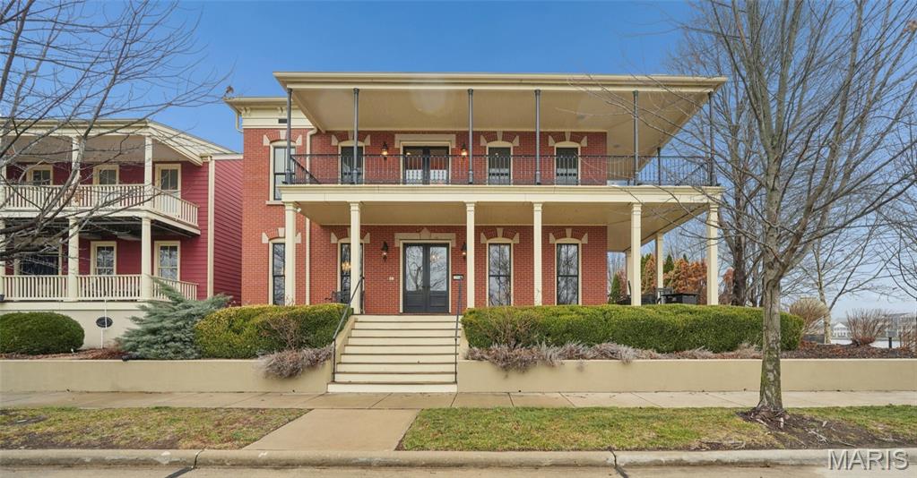 Set on a premier corner waterfront lot, this iconic New Town residence captures some of the finest views in the area.  From its double wrap-around porches and private patio to the signature third-floor panoramic sunroom, waterfront and neighborhood vistas unfold in every direction. Recognized for its grand architecture and signature crow’s nest, this custom-built home has long been one of the community’s most admired properties. Take advantage of the rare opportunity to own one of New Town’s true landmark residences. 

Inside, timeless craftsmanship meets modern luxury. Rich hardwood flooring, fresh millwork, 10’ main-floor ceilings, and updated paint and fixtures set an elegant tone. The great room impresses with built-ins and a beautifully refreshed fireplace. At the heart of the home is a gourmet kitchen made for hosting—complete with custom cabinetry, quartz countertops, Butler’s pantry, center island, wine fridge, and an all-new 2025 Cafe appliance suite including built-in refrigerator, dishwasher, wall oven, warming drawer, and 5-burner gas cooktop. 

The main-floor primary suite is a serene retreat featuring heated floors, a luxurious marble shower, soaking tub, double vanities, and an oversized walk-in closet. Upstairs, a spacious loft with wet bar, flex space, three bedrooms, two full baths, and a full laundry room offer outstanding functionality. 

The finished lower level adds even more versatility with three additional finished rooms and a full bath. Outdoors, relax on the screened-in porch or enjoy the peaceful waterfront backdrop from your private patio. A rare 4-car garage with an additional 5th parking pad and EV charger. 4-zone heating system, and laundry hookups on multiple levels every elevate convenience and comfort. 

What truly sets this home apart is how seamlessly it blends with the vibrant lifestyle of New Town—a community that feels like a little piece of a southern beach town tucked into the Midwest. Here, every day feels like a getaway. Residents enjoy multiple pools (including a lazy river), scenic lakes for fishing and kayaking, sand volleyball courts, walkable restaurants and a neighborhood market, and year-round events and parades that bring the streets to life—often passing right by your front door. It’s a golf-cart community designed for connection, charm, and the kind of everyday moments that feel anything but ordinary. With its iconic architecture, unmatched views, and the best of New Town living woven into every detail, this home is truly one of a kind.