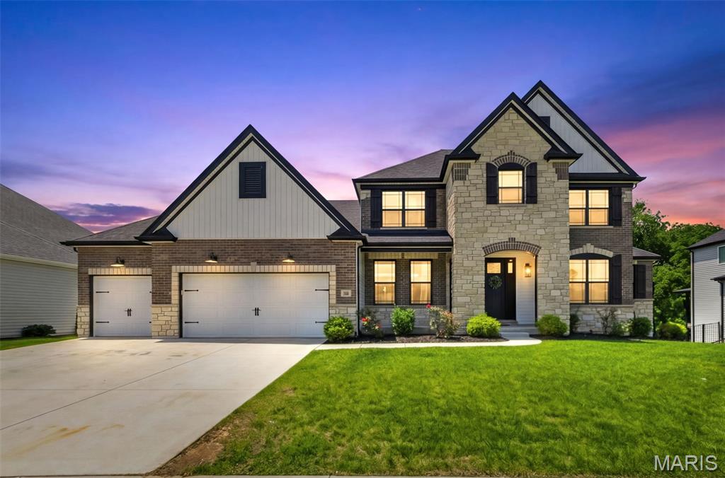 Welcome to this exceptional custom built Lombardo 1.5 story with the sought after Reinier elevation, perfectly situated on a premium wooded lot in Shady Creek subdivision and located in Wentzville School District. Offering over 3,800 sq ft of thoughtfully designed living space, this home combines luxury, functionality, and timeless style. The foyer opens to a dining room featuring wainscoting, a coffered ceiling, and designer lighting. The stunning two story great room showcases soaring ceilings, a stone gas fireplace with custom built ins, and a wall of windows overlooking the private backyard. The gourmet kitchen is appointed with 42 inch cabinetry, crown molding, stainless steel appliances, gas cooktop with arched stone surround, expansive center island, beverage bar with refrigerator, and adjoining breakfast room with access to the covered composite deck. The main level primary suite offers a coffered ceiling, bay window, spa like bath with dual vanities, soaking tub, custom tiled shower, and oversized walk in closet with custom organizers. Luxury vinyl plank flooring flows throughout the main level, complemented by a well equipped laundry room and convenient drop zone with built in boot bench. Upstairs, a spacious loft provides additional living space, while 3 generously sized bedrooms feature walk in closets and access to both a Jack & Jill bath and  en suite bath. The unfinished walk out lower level includes a full bath rough in and endless possibilities for future expansion. Backing to mature woods, the fenced backyard offers exceptional privacy and a peaceful setting for outdoor enjoyment. Combining exceptional craftsmanship, upscale finishes, and one of Shady Creek's most desirable homesites, this remarkable residence is the perfect place to call home.
