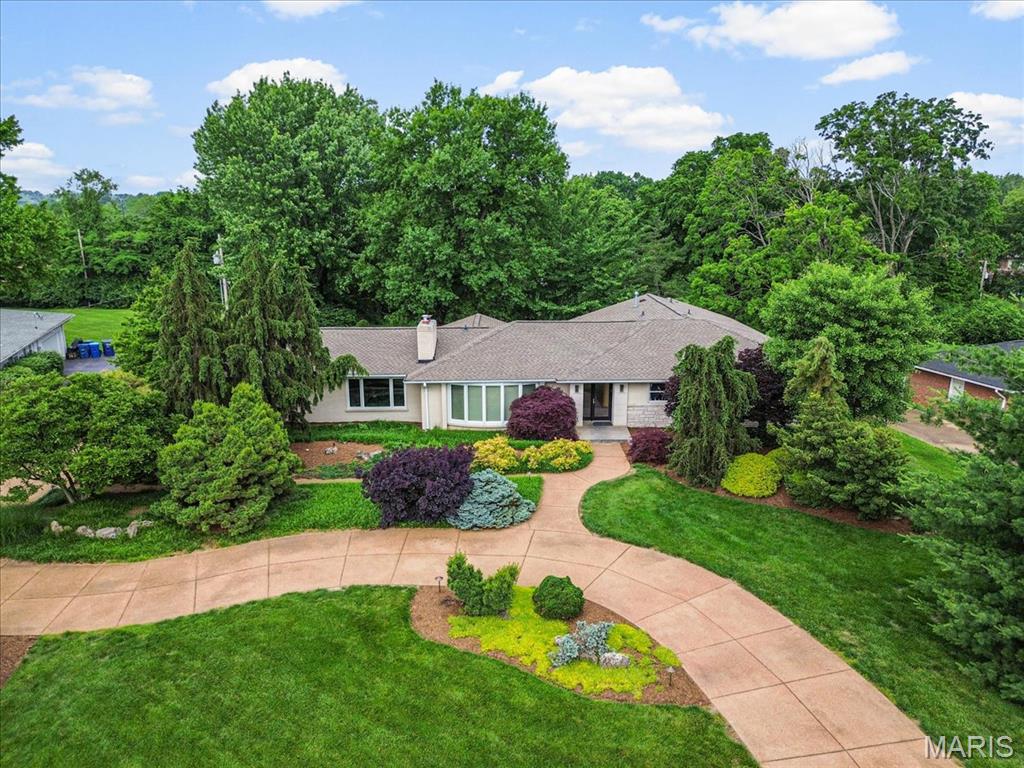 Amazing central location, great highway access, sits on 1 acre, lush garden ranch home. 4 bed/4 bath, includes 2 full master suites both with double sinks, separate jet tubs and showers. Finished walk out basement, with two storage rooms, full bath, game area, gym area and additional family room. Concrete circle driveway and a gardeners paradise, with over 40 mature, rare evergreen trees, exquisite hostas and speciality plants. Unique, contemporary home, with vaulted ceilings, updated kitchen, double see-through slate fireplace, 3 custom, built in lighted display walls for your artwork. Giant, level back yard awarded best of Creve Coeur for trees. Updated kitchen with sun filled breakfast room overlooking the gorgeous back yard. Large deck with gas grill and outdoor seating area. Kitchen has granite countertops, island, newer appliances and newer Renewal by Anderson windows. This dream home is ‘move in ready’ for a new family.