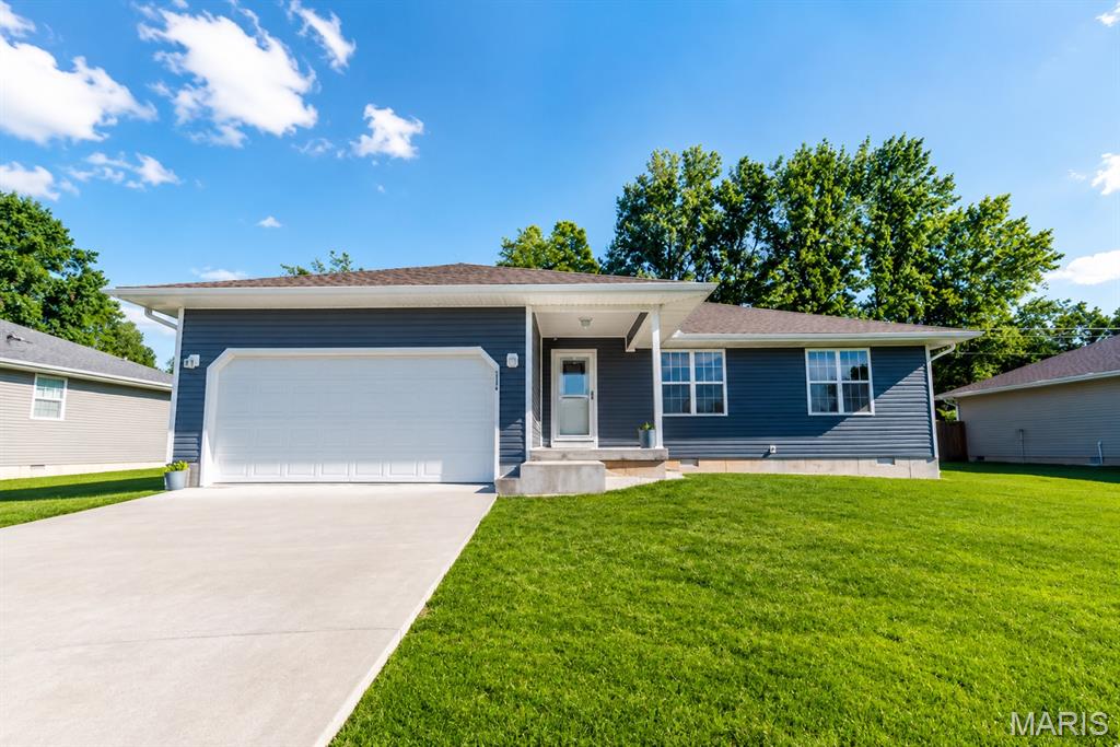 Welcome to this beautifully maintained 3-bedroom, 2-bath home that offers modern style, comfort, and functionality. From the moment you arrive, you’ll appreciate the attractive curb appeal, covered front porch, and move-in-ready condition that makes this home feel like new.  Step inside to an inviting open-concept floor plan designed for both everyday living and entertaining. The spacious living room flows seamlessly into the dining area and kitchen, creating a bright and welcoming atmosphere. Large windows and a sliding glass door provide abundant natural light while offering views of the backyard.  The kitchen serves as the heart of the home, featuring beautiful white cabinetry, ample granite counter space, sleek black appliances, and a large center island perfect for meal preparation, casual dining, or gathering with family and friends. The modern finishes and thoughtful layout make this space both functional and attractive. The primary suite provides a comfortable retreat with a private bath and generous closet space. Two additional bedrooms offer flexibility for family, guests, a home office, or hobbies. The second full bathroom is conveniently located and features clean, modern finishes. Throughout the home, you’ll find quality flooring, recessed lighting, neutral colors, and tasteful updates that create a fresh, contemporary feel. Pride of ownership is evident in every room, making this property truly move-in ready. Outside, enjoy a spacious backyard with plenty of room for outdoor activities, entertaining, gardening, or simply relaxing. The patio area is ideal for grilling and enjoying warm evenings with family and friends. A storage shed provides additional space for lawn equipment, tools, and seasonal items, while the attached two-car garage offers convenience and extra storage. Whether you’re a first-time homebuyer, growing family, or someone looking to downsize without sacrificing quality, this home offers the perfect blend of comfort, style, and practicality. Its excellent condition, open layout, modern finishes, and spacious outdoor living areas make it a standout opportunity. Don’t miss your chance to own this exceptional like-new home.
