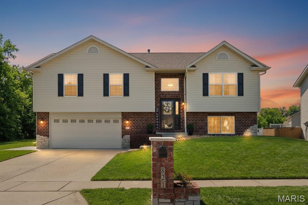 Welcome to a home that perfectly balances modern style with that warm, "lived-in" comfort you’ve been searching for! Originally built by Osborn Homes in 2012 and located in the highly sought-after O’Fallon School District, this 4-bedroom standout has been beautifully transformed with thoughtful, high-end updates—including fresh professional paint, brand-new flooring, and new interior panel doors that make the entire space feel polished and completely move-in ready.
That "home at last" feeling starts the moment you pull into the wide concrete driveway. You’ll love the instant curb appeal of the classic brick veneer paired with crisp black shutters and decorative stone accents. Even the smallest details have personality, like the custom brick mailbox with its own integrated planter. Just beyond the front walk, you’ll find an oversized two-car garage—fully finished and painted to be a clean, versatile space for a workshop, home gym, or keeping your vehicles protected year-round.
As you walk up, large multi-pane windows and a transom window promise a bright, sun-filled interior that feels incredibly welcoming. Step into the foyer where the open-concept design truly comes to life with warm wood-style wide-plank flooring, a fresh neutral color palette, and elegant wrought-iron railings. Soaring vaulted ceilings lead you into a spacious Living Room that’s just right for hosting lively get-togethers. The space flows naturally into a chef-friendly kitchen and dining area you’ll love spending time in, featuring rich oak cabinetry and a large, curved breakfast bar island designed for effortless meal prep and casual chats.
When it’s finally time to wind down, the bedrooms serve as true sanctuaries with plush neutral carpeting and a peaceful atmosphere. The primary suite is a standout retreat you’ll never want to leave, boasting its own grand vaulted ceiling, a generous walk-in closet, and a private en-suite bathroom for the ultimate serene experience. For even more flexibility, the walk-out lower level offers a cozy family room that opens directly to the backyard, along with a fourth bedroom, a convenient half bathroom, and a dedicated laundry room to keep life organized.
The outdoor space is a rare blend of privacy and peace. You can host summer BBQs on the newly built deck, or step down to the massive 52x15 extended patio where a separate pergola provides the perfect shaded spot for lounging within the fully fenced backyard. A matching storage shed ensures your gear stays tucked away, keeping the yard just as tidy and beautiful as the rest of the home.
Beyond the property, the friendly Chesapeake Junction community puts you right in the heart of O’Fallon. You’re just minutes from Scott Air Force Base and the vibrant Downtown District, home to the Vine Street Market and local favorites like Peel Wood Fired Pizza. With the 200-acre Family Sports Park nearby and easy access to I-64, you can enjoy your quiet suburban retreat while staying less than 20 minutes from the energy of downtown St. Louis!
Ready to see it for yourself? This beautiful property is even better in person! Don’t miss your chance to experience the perfect combination of neighborhood charm and easy access to all your favorite local spots. Schedule your private showing today—we can’t wait to show you around and help you imagine making this house your next home!