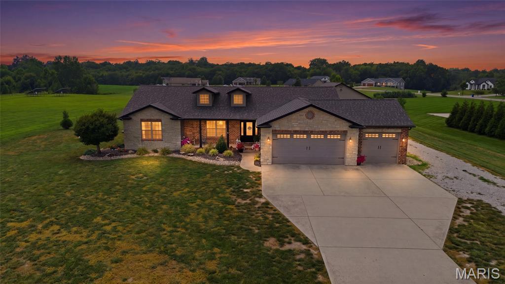 Welcome home! Beautifully updated and maintained, 5 bedroom ranch, 2 acres, and large
outbuilding! Enter into an open, vaulted, great room with gas fireplace. Spacious open kitchen
with new quartz countertops (2026), large island with breakfast bar, and beautiful cabinetry. New
kitchen and living floor (2025). The primary bedroom is located on its own wing, and features
luxury upgrades with a large walk-in closet, patio access, and bathroom remodeled in 2022.
Two additional spacious bedrooms are found on the main level, and the lower level includes two
more bedrooms, for a total of 5 bedrooms. Lower level boasts plenty of space for relaxing or
entertaining with a spacious family room and recreation area. The lower level bonus room
makes a great gym or home office. Enjoy the scenic 2 acre lot from the composite deck. Plenty
of space for storage, fun, and projects in the 30 x 45 detached outbuilding, which includes a bar
for entertaining. An additional storage shed is perfect for mower storage. The best of subdivision
living combined with a rural feel. Many updates since the home was built in 2015, including
roof (2024), sump pump (2022), septic aerator replaced (2024), water heater (2021), and
several rooms with new flooring. This home is a must see!