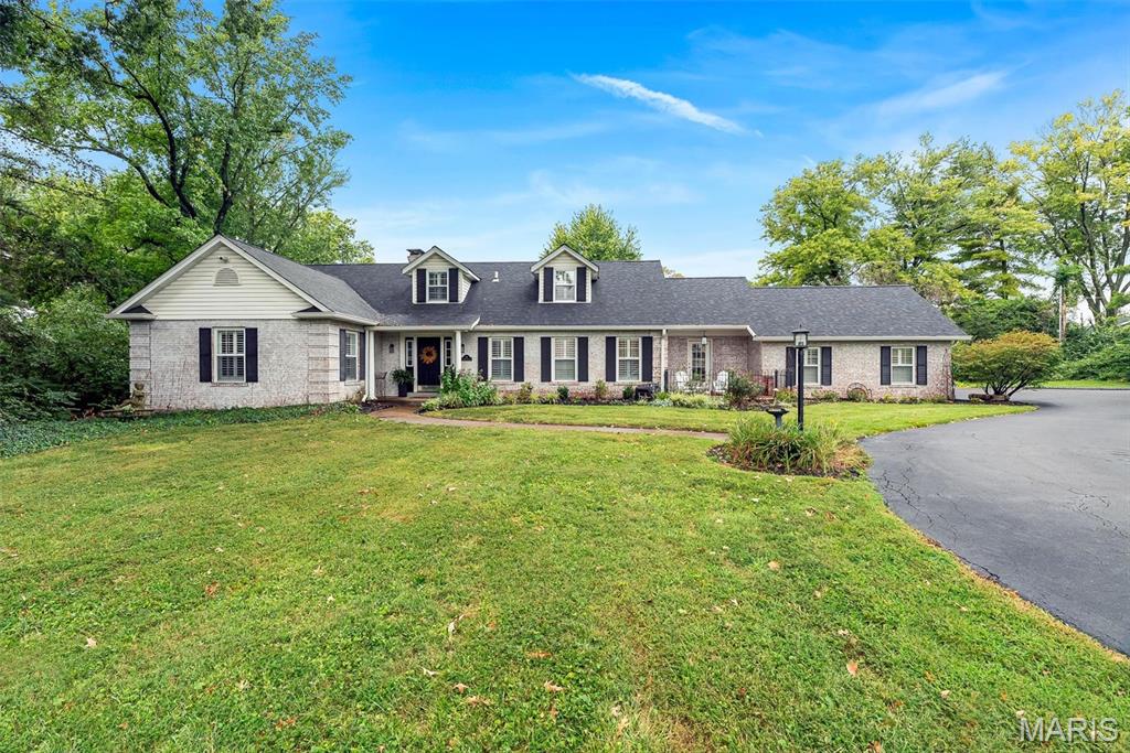 Welcome to this beautifully renovated 1.5-story home, ideally situated on a picturesque 1.28-acre lot in the heart of Town & Country. Thoughtfully transformed in 2024 with a comprehensive whole-home renovation, this exceptional property seamlessly blends timeless character with today’s most desirable finishes, modern functionality, and comfortable living spaces.

From the moment you step inside, you’ll appreciate the beautiful hardwood floors, extensive millwork, abundant natural light, and attention to detail throughout. The heart of the home is the spectacular renovated kitchen, featuring crisp white shaker cabinetry, stone countertops, stainless steel appliances, generous storage and workspace, and a large center island with seating. The kitchen opens effortlessly to the inviting family room, highlighted by a magnificent stone fireplace that creates the perfect setting for relaxing or entertaining.

The highly sought-after main-floor primary suite provides a private retreat with a beautifully renovated bath featuring dual vanities, a large walk-in shower, stylish heated tile flooring, and two thoughtfully designed walk-in closet areas. The main level also offers a convenient half bath, a dedicated office perfect for working from home, and a large main-floor laundry room designed to make everyday living easier.

Upstairs, three spacious additional bedrooms and a full bath provide excellent accommodations for family members, guests, or flexible living needs. There is abundant closet space in each bedroom including a large walk-in hallway storage closet.  The walkout lower level expands the possibilities even further, offering abundant space for recreation, hobbies, a home gym, playroom, or additional entertaining in front of the beautiful stone gas fireplace—with an additional half bath and plenty of storage in the unfinished part of the basement.

Step outside and enjoy the privacy and beauty of the expansive grounds. Mature trees, established landscaping, and 1.28 acres of gorgeous yard space create a peaceful setting rarely found so close to the amenities of Town & Country. The extended rear deck provides the perfect backdrop for morning coffee, outdoor dining, summer gatherings, and entertaining friends and family. This is a rare opportunity to own a move-in-ready property offering the space, privacy, and convenience today’s buyers are looking for.

Come see everything this exceptional home has to offer—you may have just found the one you’ve been waiting for!

Showings begin at 9:00 AM Saturday, September 12.