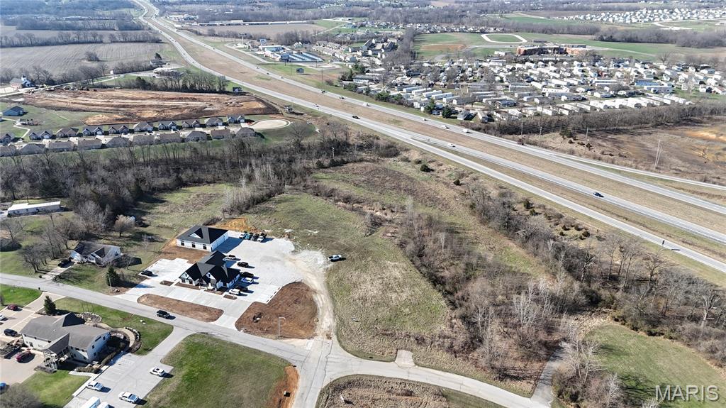 Prime 1.89+/- acre commercial lot (Lot 2) located in Moscow Mills, offering an excellent opportunity for development in a growing area. Situated within a Business Park / Industrial Park setting, this property is ideal for a variety of commercial or light industrial uses. The lot provides ample space for a building, parking, and operational needs while still allowing room for future expansion. Its convenient location offers easy access to surrounding communities and major roadways, making it an attractive location for businesses looking to establish or grow in the area. With continued development and demand for commercial space in Moscow Mills, this property presents a great opportunity for investors, developers, or business owners seeking a strategic location in a thriving commercial corridor.
