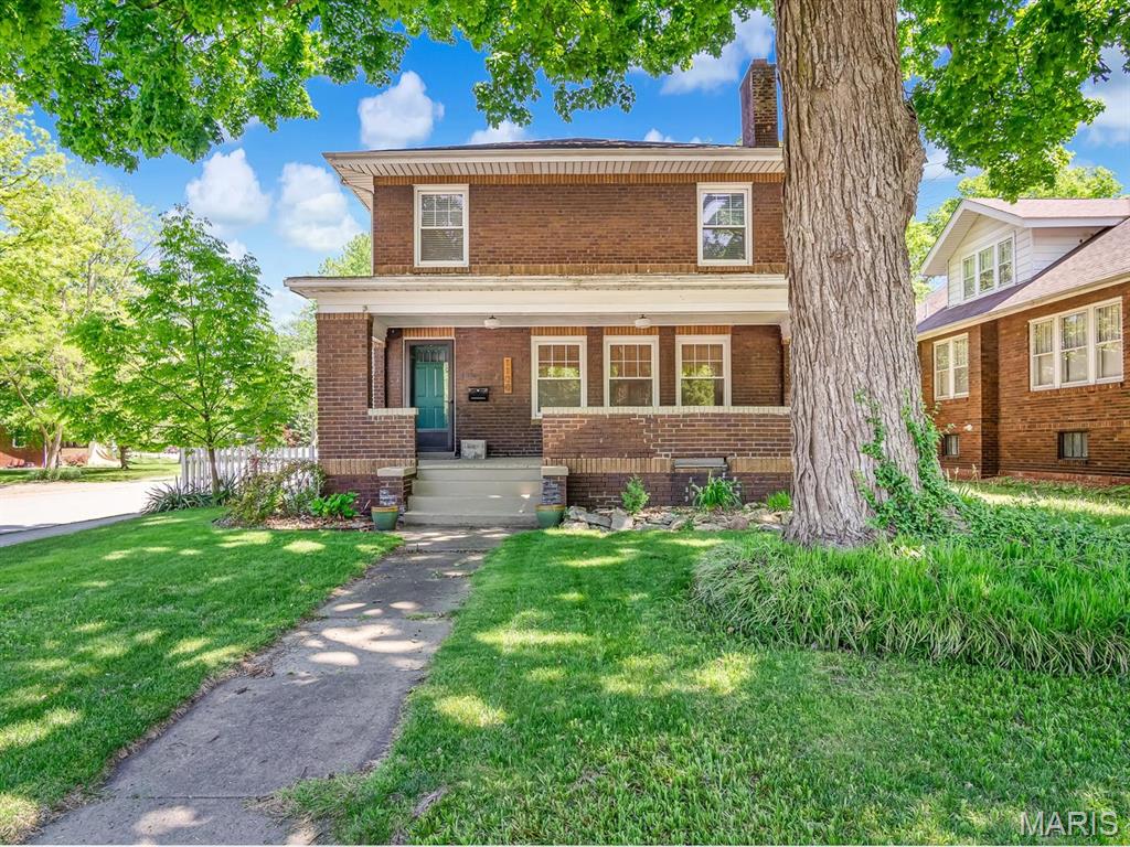 Timeless character and thoughtful updates await in this stunning all brick two story in the heart of Edwardsville.  From the original hard wood floors that have been brought back to life, you will feel immediately at home. The living room features gas fireplace with beautiful hearth surround, views of the front yard, and french doors leading to dining room with stunning lighting. Kitchen features 1.5" thick Custom all walnut butcher block countertops, farmhouse shelving & stainless steel appliances to make cooking a joy. Upstairs includes bedroom with ensuite half bath, 2 additional bedrooms, and full spacious bath that allow everyone the space they need to make mornings a breeze. Basement adds great space to the home with large family room, full bath, laundry, and storage space. The yard is your classic white picket fence with mature landscaping and room to run and play. Two car oversized detached garage is great for cars, workshop, or storage. Both front and back porches are a great escape to relax and enjoy your home. Side yard has been transformed into the perfect place to entertain. This is truly a must see to appreciate. Call your agent for your private tour!!
