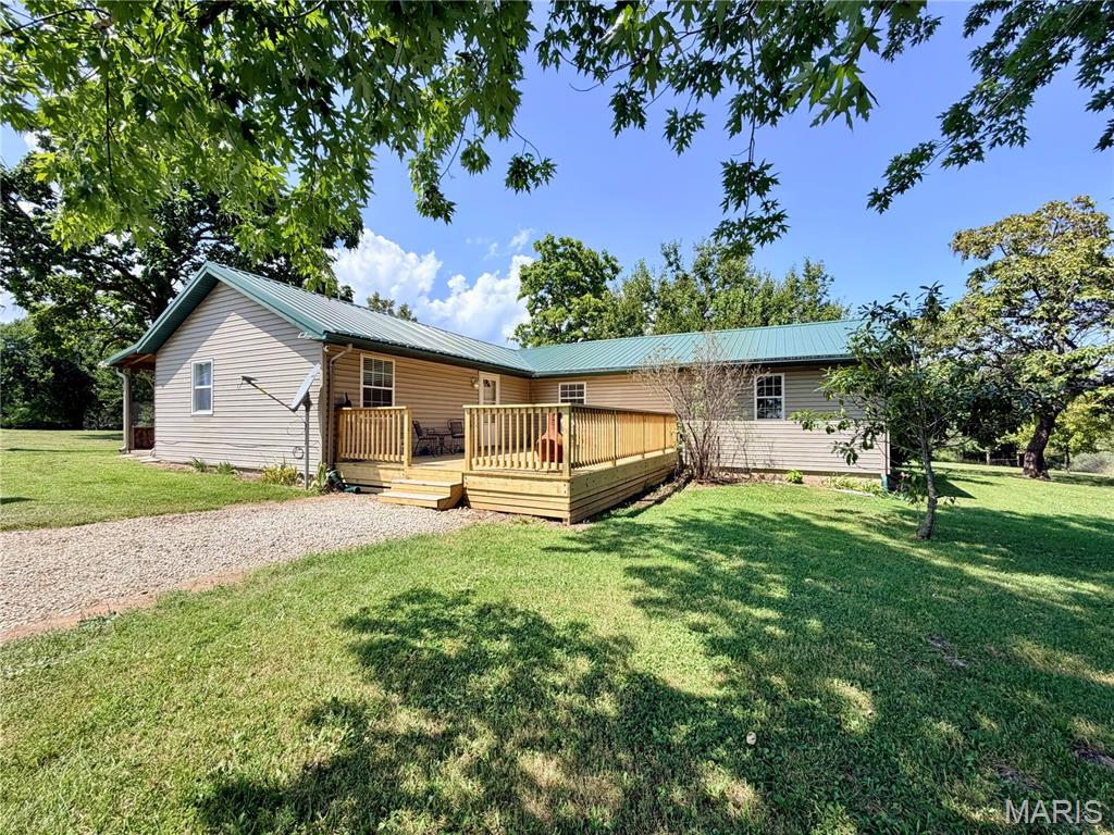 Enjoy the best of peaceful country living with this charming 3-bedroom, 2-bath home situated on 3 beautiful acres m/l. The open floor plan creates a welcoming space for everyday living and entertaining, featuring durable luxury vinyl plank flooring throughout the main living areas. A sunroom provides the perfect spot to enjoy your morning coffee or take in the surrounding views. Step outside onto the large deck, ideal for entertaining, relaxing, or enjoying the mature trees and peaceful setting. For those needing extra workspace or storage, the impressive 40x40 shop offers plenty of room for projects, equipment, hobbies, or vehicles. Raised garden beds make it easy to enjoy gardening and outdoor living, while the mature trees provide shade, privacy, and natural beauty. With three spacious acres m/l, a versatile shop, beautiful outdoor spaces, and a comfortable open-concept interior, this property offers a wonderful combination of space, functionality, and country charm.