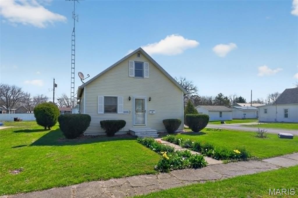 This two story bungalow on corner lot with some fencing and large yard for gardening. Inside you will find an open living room with big picture window and open to kitchen.  The kitchen features a breakfast bar and large counter space that opens up to rest of house.  The kitchen has large pantry area and includes all appliances.  The lower level bedroom features nice closet and convenient to rest of house.  Upstairs and open loft for bedrooms and can feature multiple beds or make nice suite.  An office is also located off the mud room and can be converted to small bedroom.  Garage has been converted into a great workshop with an additional office and plenty of floor space for woodworking or hobbies.  Garage would need converted back with garage doors but could possibly converted back to hold multiple vehicles.  This house is located in a very convenient main location in Gillespie close to downtown and gas stations.