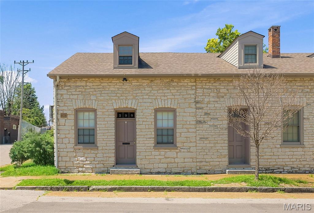 Historic charm meets modern living in this beautifully renovated 1840 stone rowhouse! Renovated in 2002, this two-bedroom, two-bath home features soaring ceilings, spacious rooms, skylights, and a stunning interior limestone wall. The vaulted kitchen is filled with natural light, while the private gated backyard offers the ideal outdoor retreat. An oversized garage provides rare convenience and extra storage. Just steps from neighborhood favorites including Perennial Artisan Ales, Sugarwitch, Stacked STL, and Riverside Diner, this one-of-a-kind home is the ideal blend of character, comfort, and location.