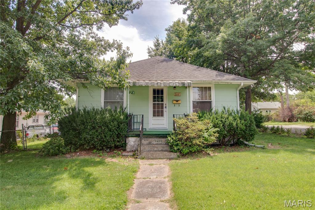 Check out this affordable 2 bedroom 1 bath home with detached two car garage. Extra parking between house and garage. Roof was replaced in 2014 as well as the AC. Refreshed kitchen cabinets have been painted white and dishwasher gas range/oven and microwave will stay! Some hardwood floors (under carpet in living and dining rooms) and beautiful original wood trim, doors and built in cabinets in dining room. Bathroom has been updated with newer vanity. Fenced back yard and screened in back porch with composite decking.
