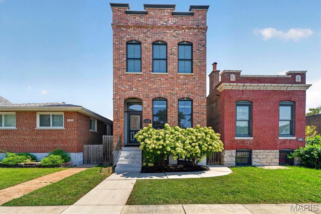 Welcome to this beautifully maintained 2-story home in the heart of The Grove, where classic St. Louis style meets modern city living! Built in 2017, this spacious 2,200-square-foot home offers 3 bedrooms, 2.5 baths, soaring 10-foot ceilings, hardwood floors, crown molding, and striking red brick details throughout. The open floor plan creates an inviting flow from the generous living room into the dining area and stylish modern kitchen, making everyday living and entertaining feel effortless. A convenient half bath completes the main level.
Just beyond the kitchen, a second living space offers even more room to relax, work, or entertain and opens directly to the deck and private backyard. String lights create the perfect atmosphere for evening gatherings, while the carport with garage door provides convenient off-street parking and added security. The decks have been freshly painted, and new interior paint adds to the home's fresh, move-in-ready feel.
Upstairs, you'll find three generously sized bedrooms, each offering walk-in closet space, along with a convenient laundry closet and full guest bath. The spacious primary suite is a true retreat, featuring its own walk-out balcony and a beautifully appointed bathroom with double vanity, soaking tub, and separate shower.
Need more space? The large basement offers plenty of room for storage, a home gym, office, hobby space, or whatever your lifestyle requires. Thoughtfully designed, exceptionally well maintained, and packed with both character and modern conveniences, this home truly delivers.
And then there's the location! Enjoy being within walking distance of BJC, neighborhood restaurants, bars, coffee shops, and all the energy and convenience The Grove has to offer. City living doesn't get much better than this!
