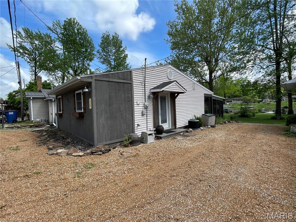 Lakefront cabin on leased property within a country club community offering fishing and water access, being sold fully furnished. This property includes a stackable washer and dryer, all appliances, golf cart, and pedal boat.
Interior features include an updated kitchen and bathroom, newer windows, central air and heat, along with a wood-burning stove in the living room for supplemental heat. Screened-in back porch provides additional outdoor living space with lake views.
Exterior includes a personal dock for direct water access.
Leasehold interest and country club membership required; community amenities include pool, tennis courts, and golf, all within walking distance.