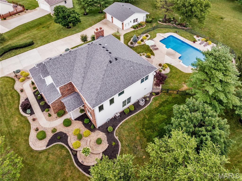 Discover this Unique Custom Built open floor plan 2 story home, nestled on almost 2 beautiful acres. Detached oversize 3 car garage.Floor to ceiling windows accent the 2 story family rm* fire/pl*updated kitchen*refinished h/wood floors* new s/surface*counter tops*back splash*center island*coffee center*w/pantry. Custom 42 inch cabinets with crown molding.Breakfast rm*b/window offers access to huge patio *gorgeous back yard*salt water inground pool*diving board and soaking station. formal dining rm *2 story entry foyer & living rm *floor to ceiling windows. Den offers custom built shelving. MFl* Open & Split stair case welcomes you to the upstairs. The balcony over looks lower level*Spacious Primary bedroom  offers a sitting rm with custom shelves*crown molding and oversize bath features seperate adult height vanities* sep shower and soaking tub. Walk in closet. 3 addtionalspacious bedrms with walk in closet*planning or game station in 2 bedrms. 9' pour in basement & f/place w/out from basement to oversize 2 garage. Dual HVAC   Easy access to hwy 40 & 70. Great place to live. Close to conveniences but country setting. Beautiful landscaping all backing to open fields