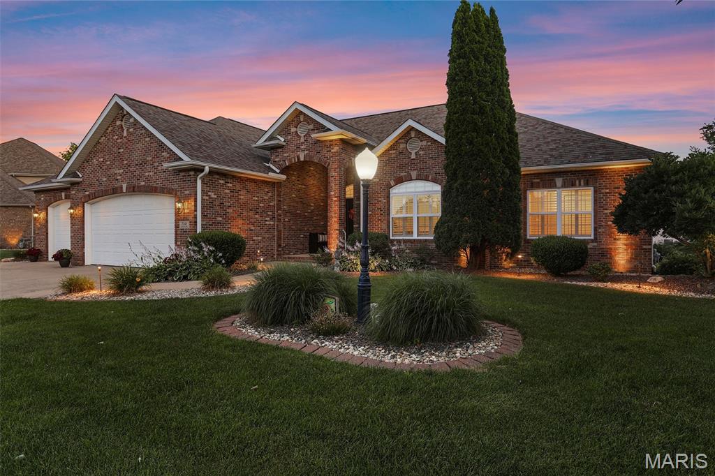 Exceptional craftsmanship & resort-style outdoor living define this custom 4-bedroom ranch in one of Edwardsville’s most desirable neighborhoods. Rich hardwood floors, architectural details & a striking oak-paneled coffered ceiling create a warm, refined atmosphere, while a wall of windows accented with stained glass fills the living room with natural light. Arched display niches flanking a fireplace, custom millwork & an open floor plan add character & elegance throughout. The chef-inspired kitchen features granite counters, abundant cabinetry, generous prep space & an expansive bar-height island perfect for gathering. The private owner's suite offers a customized walk-in closet & spa-like bath with dual vanities, tiled walk-in shower & soaking tub. Two additionall bedrooms, a full bath & a thoughtfully designed laundry/mudroom complete the main level. An extra-wide, open staircase leads to the finished lower level where entertaining takes center stage. Enjoy a custom wet bar with kegerator, spacious family room with decorative ceiling beams, 4th bedroom, full bath & bonus room perfect for an office, hobbies or personal gym & storage. Step outside to your own backyard retreat. A heated saltwater pool, Trex deck, paver patio, built-in fire pit & professionally designed landscaping create 3 distinct outdoor living spaces ideal for relaxing & entertaining. Additional highlights include a fenced yard, backup sump pump & newer HVAC ‘21. Close to schools, MCT trails, the YMCA, shopping & dining.