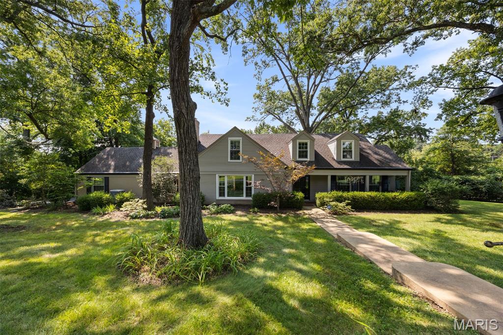 Nestled on a tranquil one-acre lot located on a cul-de-sac, this delightful Cape Cod with a first floor primary suite offers the perfect blend of peaceful surroundings, spacious living, and timeless charm. An absolute gem! Thoughtfully designed for both everyday comfort and effortless entertaining, the home’s flowing floor plan is complemented by generously sized rooms filled with natural light. A welcoming living room showcases rich hardwood floors, a cozy gas fireplace, and an expansive picture window overlooking the beautifully landscaped front yard. The adjoining dining room, accented with classic picture molding, provides an inviting setting for holiday gatherings and memorable celebrations. The spectacular family room is truly the heart of the home, featuring a soaring vaulted ceiling, a dramatic wall of windows, and French doors that open seamlessly to the patio and private backyard oasis, where mature trees create a serene natural backdrop. The sun-drenched kitchen is as functional as it is beautiful, boasting abundant cabinetry, extensive counter space, a gas range, and a striking designer range hood. Whether preparing everyday meals or entertaining guests, this well-appointed space is sure to impress. The coveted main-floor primary suite serves as a private retreat, complete with a spacious spa-inspired bath featuring a zero-entry shower and an exceptional walk-in closet worthy of any fashion enthusiast. Upstairs, two generously sized bedrooms provide inviting spaces for rest and relaxation. Storage is abundant throughout the home with multiple walk-in closets, while the oversized two-car garage offers even more room for vehicles, hobbies, and organization. Enjoy the convenience of quick access to major thoroughfares while coming home each day to the quiet beauty and peaceful setting that make this exceptional property so special. New HVAC in 2025. Tankless water heater.