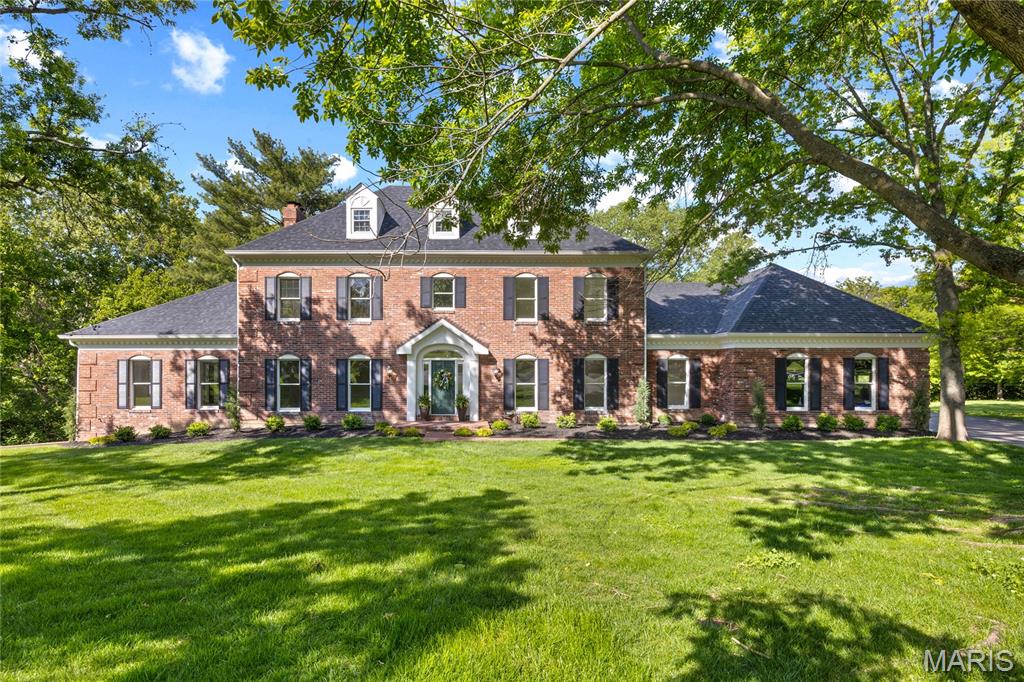 Prominently situated at the end of the cul-de-sac, this stately Miceli-built Georgian Colonial makes a stunning entrance. Distinctive design elements complement the exceptional craftsmanship evident throughout the home. Wide brick porch entrance leads to impressive 2-sty foyer lined with herringbone hardwoods that extend into well-appointed living & dining rooms and library-paneled family room with box beam ceiling, wet bar, floor-to-ceiling brick fireplace flanked by built-in bookcases & bank of windows. Chef’s kitchen featuring oak cabinetry, stainless steel appliances & 6’ center island adjoins breakfast room with convenient planning center & atrium doors that open to private deck that overlooks the lake. Coffered primary bedroom suite with 2 walk-in closets, luxury bath with freestanding tub & adjacent study offers an appealing retreat. Front & rear staircases access 3 generous-sized additional bedrooms, 1 with ensuite bath, & hall full bath plus bonus loft room. Parklike 1.2-acre grounds include screened porch, composite deck, covered patio & 3-car garage.