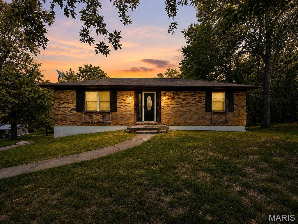 Welcome home to this well-maintained brick ranch nestled on a beautifully shaded lot in the highly sought-after Terre Du Lac lake community! Surrounded by mature trees and offering a peaceful, park-like setting, this 2-bedroom, 2-bath home combines comfort, convenience, and endless recreational opportunities. Featuring over 1,500 square feet of finished living space, including a partially finished walk-out lower level, there's plenty of room to spread out and enjoy.  Step inside to find an inviting open-concept living, dining, and kitchen area that creates the perfect space for everyday living and entertaining. The main level offers two spacious bedrooms and a full bath, while the lower level provides a large family/recreation room, an additional bath, and flexible space ideal for a home office, gym, hobby room, or guest accommodations. The attached two-car garage adds convenience, while the wooded surroundings offer privacy and a relaxing atmosphere. Located within the private Terre Du Lac community, you'll enjoy access to multiple lakes, boating, fishing, swimming, golf, parks, and community amenities right outside your door. Whether you're looking for your first home, a place to downsize, a weekend getaway, or a year-round residence, this charming property offers the perfect blend of comfort and lake-community living.
