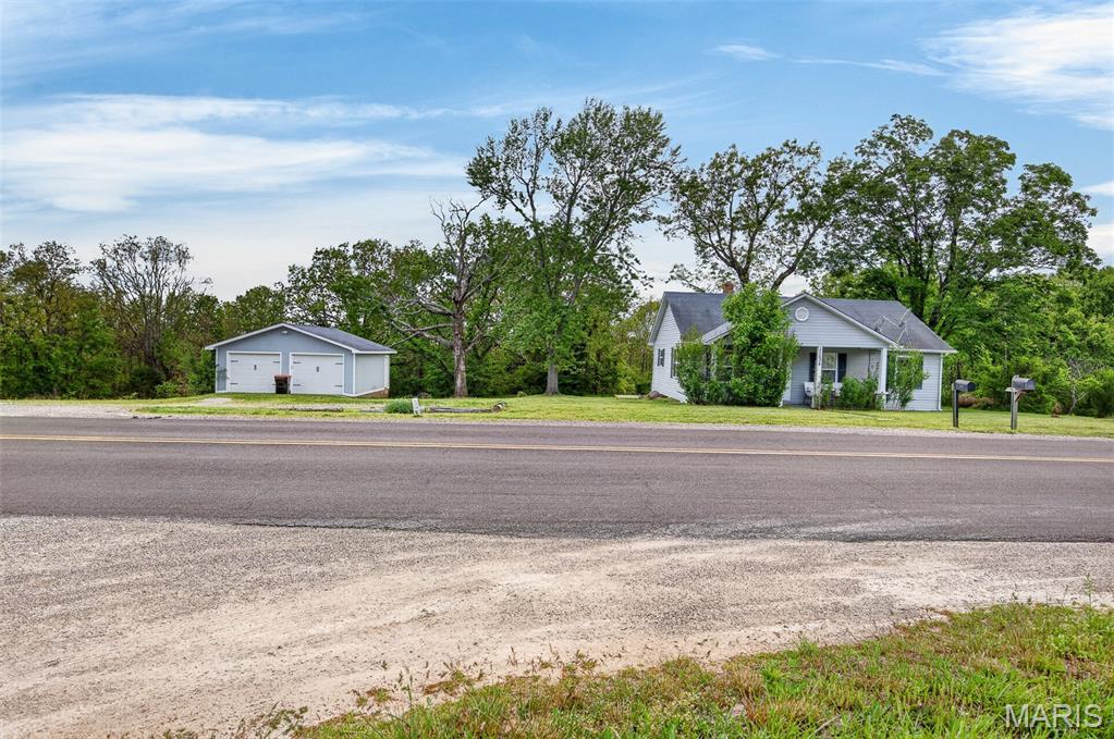This one is it! Take a look at this adorable bungalow conveniently located close to I-44 and the west gate of Fort Leonard Wood. This 2 bedroom, 1 bathroom home is currently being used as a 3 bedroom thanks to a tandem room that offers flexible space for an additional bedroom, office, or nursery. Step inside and notice the charm of the hardwood floors along with the spacious living and dining area. The kitchen has been updated with trendy modern colors and features a large stainless refrigerator and gas range. The bedrooms share a common bath, while the primary bedroom connects to the tandem room for added versatility. Outside, you'll find a nice detached 2-car garage, all situated on 9.15 acres. As an added bonus, the home is currently operating as an active Airbnb, and the seller is willing to sell it furnished for an additional price.