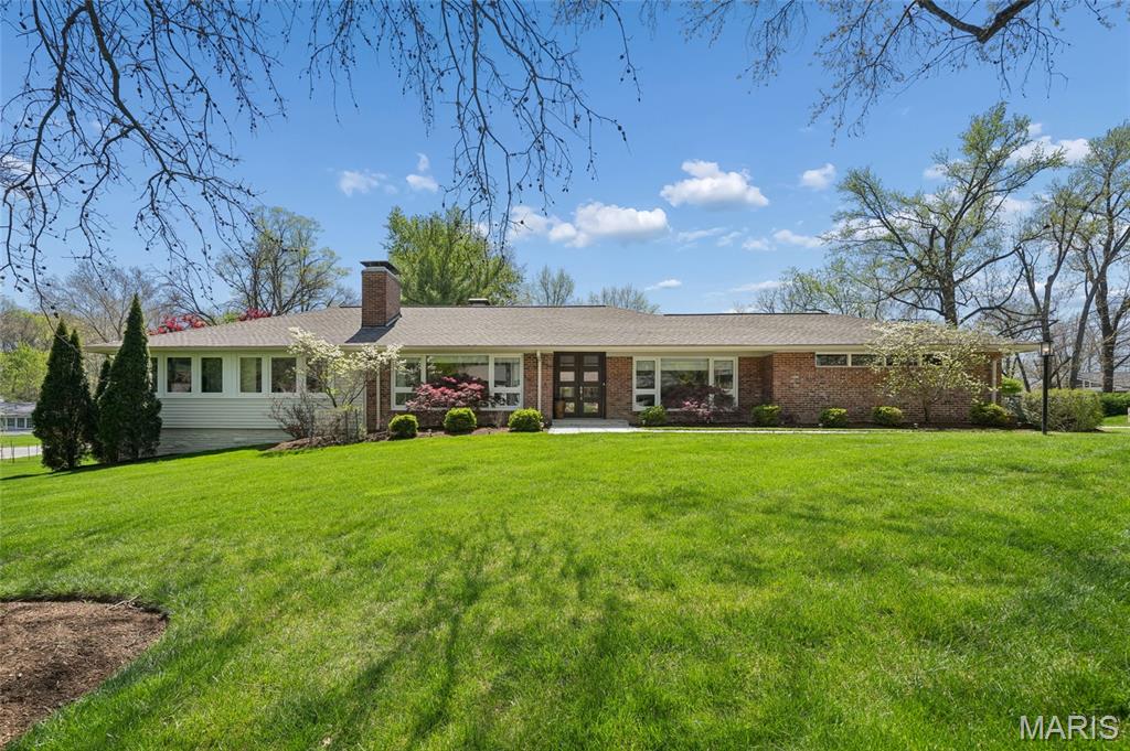 Completely reimagined from top to bottom, this stunning mid-century modern ranch blends timeless architecture with refined contemporary living. High-end materials and custom finishes are showcased throughout, creating a cohesive and sophisticated aesthetic.
The open-concept main level is filled with natural light from expansive windows and offers generous living spaces designed for both everyday comfort and elevated entertaining. All primary living areas are conveniently located on the main floor, making this home an ideal condo alternative.
The home features three main-level bedrooms, including a serene primary suite with a spa-inspired bathroom complete with a luxurious steam shower. The chef’s kitchen is appointed with granite countertops and stainless steel appliances, adjoining  to the living and dining areas. Additional interior highlights include two gas fireplaces and a thoughtfully designed coffee station.
The finished lower level expands the living space with a large sleeping area, recreation space, a versatile room currently used as a gym, and abundant storage.
Outdoors, a private retreat awaits. The professionally landscaped grounds feature specimen trees and vibrant flowering gardens, providing year-round beauty. A spacious stone patio with built-in gas grill overlooks a tranquil water feature, offering a serene setting for entertaining or quiet relaxation.
This exceptional residence offers effortless luxury, thoughtful design, and an inviting indoor-outdoor lifestyle. 2 car garage and electric charging station. Close to  Ladue primary, middle and high schools and MICDS.