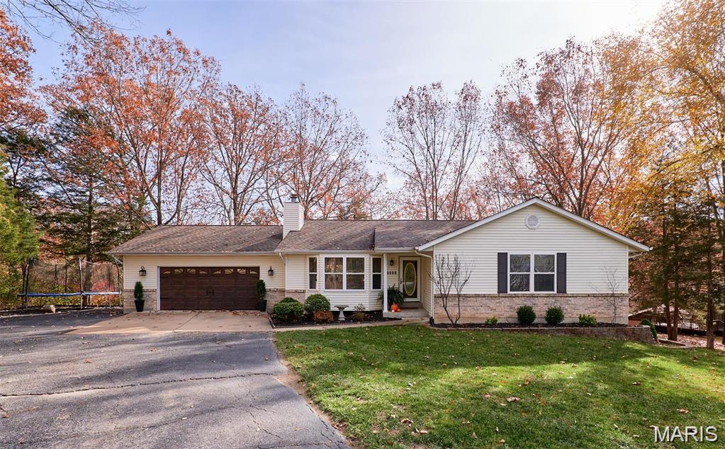 Tucked away on a private, tree-lined lot, this beautifully maintained 3-bedroom, 2-bath ranch offers the perfect blend of comfort, style, and tranquility. From the moment you arrive, you'll appreciate the peaceful setting and inviting curb appeal. Inside, soaring vaulted ceilings create an open and airy atmosphere throughout the main living areas, while rich hardwood flooring adds warmth and character.

The spacious living room features a charming wood-burning fireplace and a large bay window that fills the space with natural light. The well-designed floor plan includes a generous primary suite complete with dual walk-in closets and a luxurious ensuite bath featuring double vanities.

The kitchen opens to a large deck through elegant French doors, creating the perfect space for entertaining or simply enjoying the scenic backyard views. Surrounded by mature trees, the backyard provides a private retreat you'll enjoy year-round.

The full basement has already been framed and includes a bathroom rough-in, offering endless possibilities for additional living space, a recreation room, home office, or guest suite. Recent updates include a newer roof and HVAC system, providing peace of mind for years to come.

If you're looking for a move-in ready home with privacy, character, and room to grow, this is one you won't want to miss!
