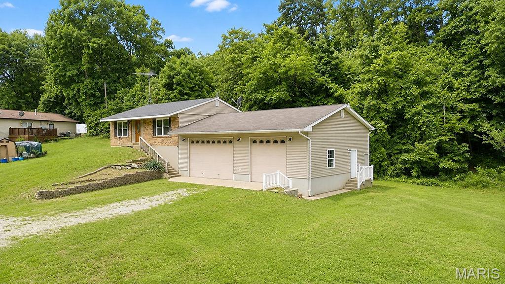 Discover a life of comfort and convenience at 14781 Hardin Rd, (Bonne Terre) per tax record but home is located in Jefferson County, MO 63628 (zip code is Bonne Terre), The MLS system will not allow me to put Bonne Terre because Bonne Terre is technically not a Jefferson County town. Built in 1986, this single-family residence offers a unique opportunity to embrace a relaxed lifestyle. This inviting home features two well-appointed bedrooms, providing comfortable private spaces for residents. Complementing these are two full bathrooms, designed for both functionality and ease. Located near both main floor bedrooms is a laundry shoot. An attic fan is one of the favorites of the seller. The lower level has a potential primary bedroom suite with ceramic shower that has a waterfall showerhead. Primary closet is located through the laundry room and has a unique upper level for added storage, kids play area, or a hangout for memorable items. The HVAC, carpet, painting, roof on house & soffit are newer. This property is an ideal setting for those seeking a manageable yet comfortable living space. Inquire today to schedule your private viewing and experience the potential of this charming home. Also enjoy the attached 3 car garage with workshop area and plenty of storage. A pulley system is installed for easy access to storage areas. The garage is able to accommodate 2 compact cars and 3rd bay is large enough for a big truck. Seller is leaving the ladder, bicycle, fishing pole racks, along with a 220 heater that needs to have the wires connected and 2 hallway doors. The garage has been drywalled, with a great place to enjoy family events. The yard is a prefect place to play games, relax, and make many family memories.