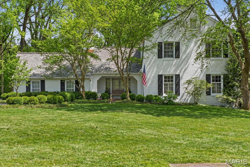 Traditional Colonial Elegance in the coveted, tree-lined Hermitage Hill neighborhood! This sophisticated, designer-inspired residence is sun-drenched and impeccably curated, offering exceptional flow and elevated finishes throughout.  Extensively upgraded for today’s luxury buyer, the home features fully resided and freshly repainted exterior, DaVinci composite shake shingles, new dual-zoned HVAC, newer windows throughout, portable generator, copper flashing, and a stunning new brick walkway that sets the tone upon arrival.  The main level was designed with effortless entertaining in mind. An expansive, elegant living room with gas fireplace flows seamlessly to a gracious family room anchored by a grand wood-burning fireplace. French doors open to the private, serene patio and professionally landscaped grounds, creating the perfect indoor-outdoor lifestyle. The eat-in kitchen showcases a wall of windows overlooking the lush yard, while the formal dining room with bay window provides a refined setting for gatherings.  Upstairs, retreat to four well-appointed bedrooms, two full baths, and the convenience of second-floor laundry. The beautifully finished lower-level rec room adds valuable living space and features a cedar walk-in closet and thoughtfully designed mudroom area.  Additional highlights include rich hardwood floors throughout, an oversized rear-entry two-car garage with EV charging station, and magazine-worthy curb appeal.  Absolutely oozing with charm, light-filled and timeless, this exceptional Frontenac residence — served by award-winning Ladue Schools — is truly something special.