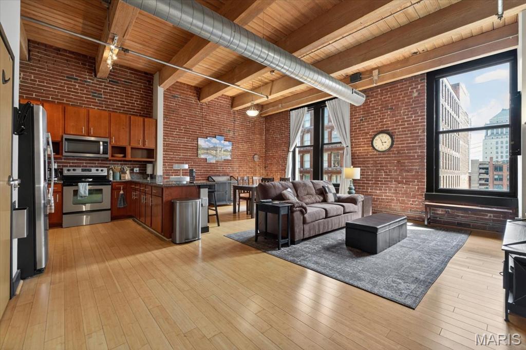 Gorgeous former display unit in the Lucas Lofts building is move in ready. Soaring wood planked ceilings create a spacious open concept living atmosphere. Tons of exposed brick, hardwood floors, and massive windows provide the ultimate loft living experience. Two generous sized bedrooms with ample closet space, spacious full bath, and in unit washer/dryer finish off the living space in this spectacular loft. This unit also offers a separate vanity outside of the bathroom that most units do not enjoy. AC and furnace recently replaced and a ton of lofted storage space added. Only two prior owners means this unit is in great shape. The sale of this loft includes one assigned parking space in the secured parking garage and a storage unit. Your low monthly HOA fee includes access to the rooftop deck with splash pool, internet, cable, water, sewer, and trash. Don't wait, schedule your showing today!