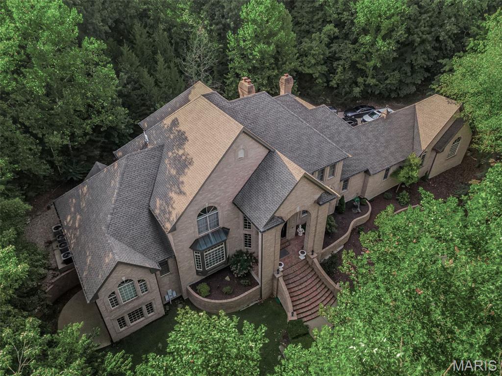 *** Priced at only $166/sq ft of living space!!!***
Welcome to your dream estate! Custom-built, all-brick luxury home sits atop 3 private acres in an exclusive enclave of just five homes. Perfectly located minutes from Tesson Ferry, near Mercy South, the YMCA, Starbucks, Dierbergs, and more. 5 bedrooms (plus potential 6th in basement); 7 Bathrooms (4 full, 3 half); 3 Fireplaces; 10,000+ sq ft of living space.  

Step into a grand double spiral staircase foyer w/ marble flooring that sets the tone for this elegant home. The atrium-style family room boasts soaring 22-foot ceilings, floor to ceiling windows, custom millwork, custom shelving, wet bar and fireplace. Updated kitchen with attached hearth room w/ fireplace. Elegant dining room w/ coffered ceiling. Huge master suite w/ jacuzzi tub, separate shower, his & hers vanities. 

Entertainer’s Dream Basement: 3773 Sq ft of fully finished living space, 10’ Ceilings, HUGE family room w/ Commercial-sized bar, Game room, Billiards room, Library, Display room, Bonus room (potential 6th bedroom), Full bath, Hidden safe room behind the bar, Walkout to side patio. 

Recent updates include: New roof, New flooring, Updated kitchen & bathrooms, Fresh paint throughout

Enjoy the luxury of stained glass windows, freestanding dual spiral staircases, and serene views from every room. This home offers the perfect blend of grandeur and comfort. You simply must see this home in person as there are too many custom upgrades to mention them all.

See virtual tour link below.