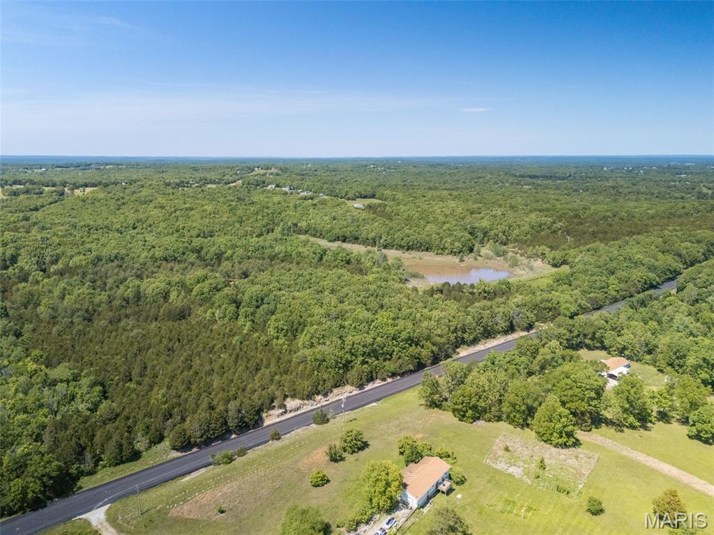 A rare and unique opportunity to purchase 68 +/- acres less than 5 minutes from school and shopping, but with the privacy and wildlife of a destination hunting excursion.  Almost 1,500 feet of State Route 21 highway frontage.  The dam of the lake is licensed and regularly inspected by the Missouri Dept. of Natural Resources.  This property was originally planned to be phase 2 of an adjacent subdivision.  The possibilities between investment property and private oasis are exponential.  Seller already possesses the permits required by DNR to repair the lake.  Willing to divide.