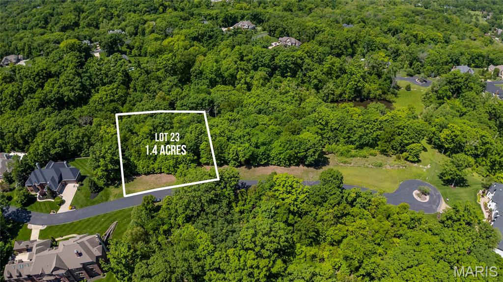 This is your opportunity to build your dream home in a truly picturesque setting! Beautifully landscaped entrance with the stone gatehouse and tranquil pond set the scene for one of the premier neighborhoods in West County! 
Over 1 acre lot is set along the meandering streets with private, wooded lots and exquisite custom homes. This is a true retreat just minutes from the popular Chesterfield Valley. Bring your own plans and builder. All lots are also on public water and sewer ~ a bonus for the location and lot sizes!