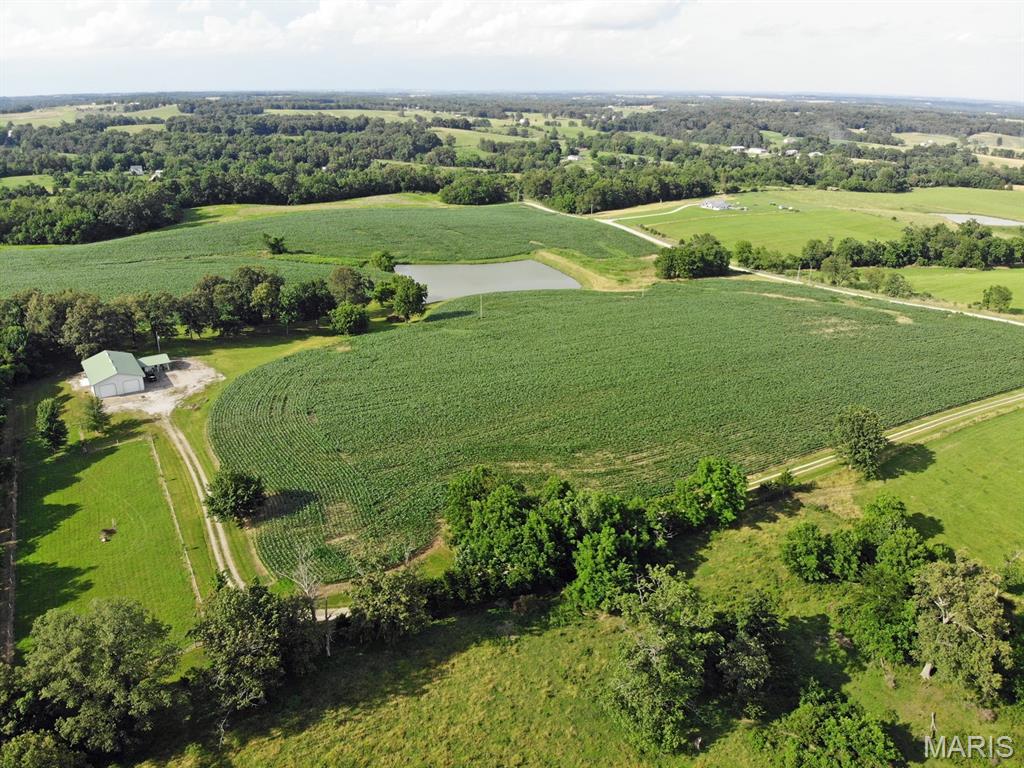 Rare opportunity to own a private 43-acre retreat featuring a stocked 2-acre pond, income producing tillable acreage, and a versatile shop/residence located well off a quiet dead-end country road.
This unique property offers the perfect blend of recreation, income, and privacy. Approximately 33 acres are tillable, providing income potential. The remaining acreage includes a beautifully maintained park-like home site with mature trees, and additional wooded areas ideal for hunting or enjoying nature.
The residence is thoughtfully integrated into a 72’ x 42’ shop building, offering approximately 1,350 sq ft of comfortable living space with 2 bedrooms, newly remodeled full bath, kitchen with full appliances and laundry closet with washer & dryer. A recently added wet bar with Granite countertop and built-in Sub-Zero fridge plus two refrigerated drawers is a great addition for entertaining. The highlight of the home is the spacious 22’ x 17’ great room featuring a floor-to-ceiling stone gas fireplace and windows on three sides overlooking the pond providing a truly exceptional setting with year-round views.
The large shop/storage area provides outstanding functionality with two oversized 14’ x 12’ overhead doors with openers, ideal for equipment, RV storage, workshop use, or hobby space. Whether you’re a contractor, farmer, or outdoor enthusiast, the flexibility of this space is a major asset.
Property includes private well, septic system, electric service, and heat pump HVAC. A long gravel driveway ensures privacy and seclusion, with the home barely visible from the road.
This is an ideal property for a full-time residence, weekend retreat, or combination of both, offering fishing, hunting, income potential, and peaceful country living all in one.
Properties with this combination of acreage, water, privacy, and utility are rarely available. Schedule your private viewing today.