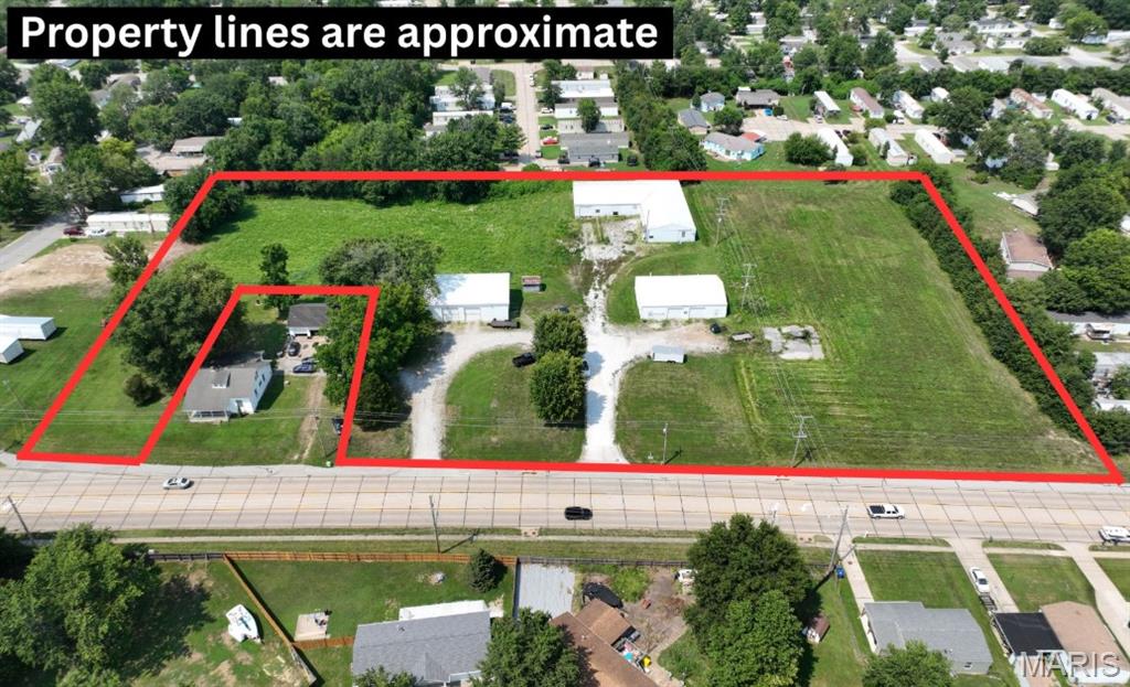 Exceptional opportunity to own 6.12 surveyed acres in one of O'Fallon's most desirable and rapidly growing commercial corridors. Zoned I-2 Heavy Industrial, this versatile property offers outstanding potential for industrial, commercial, or investment use. All public utilities are available, and the property features two existing road cutouts/access points, providing excellent accessibility and flexibility for future development. The gently rolling terrain offers an ideal building site with approximately 550+/- feet of road frontage, allowing ample space for expansion, multiple access points, or a variety of business operations. Three existing buildings are currently located on the property, creating immediate income-producing potential or the opportunity to establish and operate your own business while planning for future growth. Whether you're an investor, developer, or business owner, this property presents endless possibilities in a high-demand location with exceptional visibility and convenient access to major transportation routes. Don't miss this rare chance to secure industrial acreage in thriving O'Fallon. Schedule your private tour today or call for additional information.