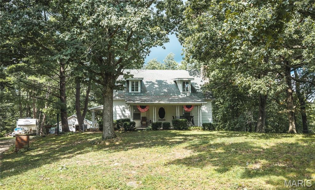 Close to the Meramec River, Close to Steelville, Close to Cuba, Close to Hwy 44...... what else could you want? Weekend, full time or BNB rental... Cabin feel, but  lot of space in this home the features include open living space, solid wood floors and Authentic Wood Beams, Wood burning Stone Fireplace, Main Floor Primary, Living Room, Dining Room, Kitchen and Bathroom on the First Floor, Take the Extra Wide Stairway that leads to the upstairs to 3 more Bedrooms, Bathroom and Bonus Room. So much Storage!! Detached 2 car garage with Additional workshop, a Large 3 bay carport, and outside patio and stone firepit. Space to garden, and a chicken coop on 6.6 +/- Acres. Call today to come and see all this home has offer!!