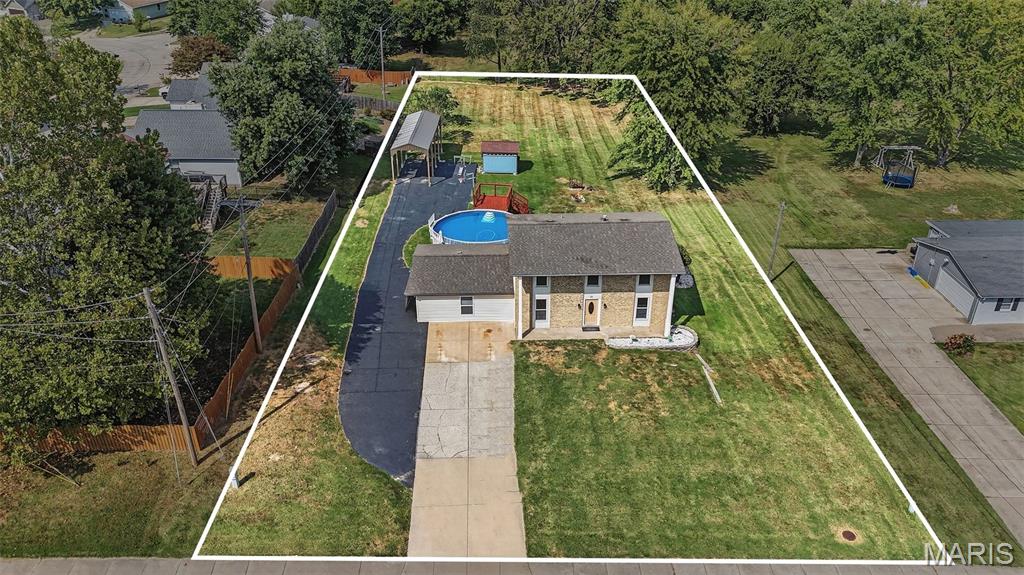 Anyone looking for a unicorn? This property is in the middle of St. Peters, almost an acre, unincorporated and has NO HOA! Freedom alongside convenience is finally available! As you walk around outside, a sizeable front yard sets the home back from street traffic - there's room to park a 5th-wheel camper AND the truck in the driveway! When not in use, don't worry about storing that camper or boat somewhere else - the driveway extends down the property line and hosts an impressive 11'x40' carport for your big-kid toys! Behind the house - a massive, park-like backyard beckons you to frolic, then cool off in the 27' pool or lounge on the large deck with privacy screen! There is even a 10'x12' utility shed to easily store yard tools, pool equipment and anything else for the off-season. Inside there are more joyful surprises! A brand-new front door, new LVP flooring on the main level, beautifully refinished original hardwood throughout the second floor and lighted ceiling fans in every bedroom, dual closets in the primary bedroom, renovated bathrooms, an incredible rec room just off the sizeable kitchen with TONS of cabinets, new epoxy counters that include a wraparound breakfast bar and newer stainless steel appliances, a separate dining room, another bonus space with French doors (home office, music room, play room or library?),  fresh paint throughout and a blank slate in the basement for you to personalize.  ALL appliances stay, even the fridge, washer & dryer! This one is an absolute dream of a wish list with every item checked! Come imagine your life in this oasis - without an hour-long commute!