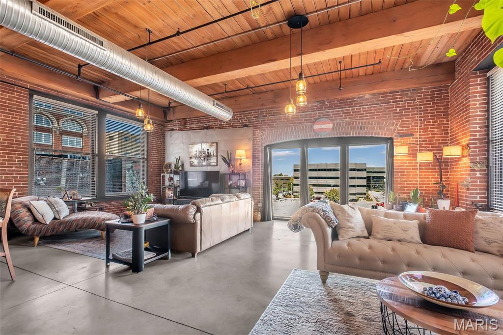 Be a part of the Washington Avenue resurgence! Investment in downtown STL is on the rise with much of it focused on this block of Wash Ave. This 1-bed, 1.5-bath loft in the heart of downtown combines industrial style with modern convenience. Concrete floors, exposed brick walls, and high ceilings give the loft a chic, industrial vibe, while large windows on three sides fill the living room with natural light. The open kitchen, complete with a breakfast bar, seamlessly connects to the dining and living areas—perfect for entertaining. The spacious primary suite features a full bath with a separate tub and large shower, and the walk-in closet connects directly to the laundry room for added convenience. Amenities include an assigned parking space in a basement garage, a community workout facility, and access to a rooftop deck with city views. With vibrant bars, restaurants, and more right outside your door, this loft is an ideal downtown haven! Location: City, Downtown