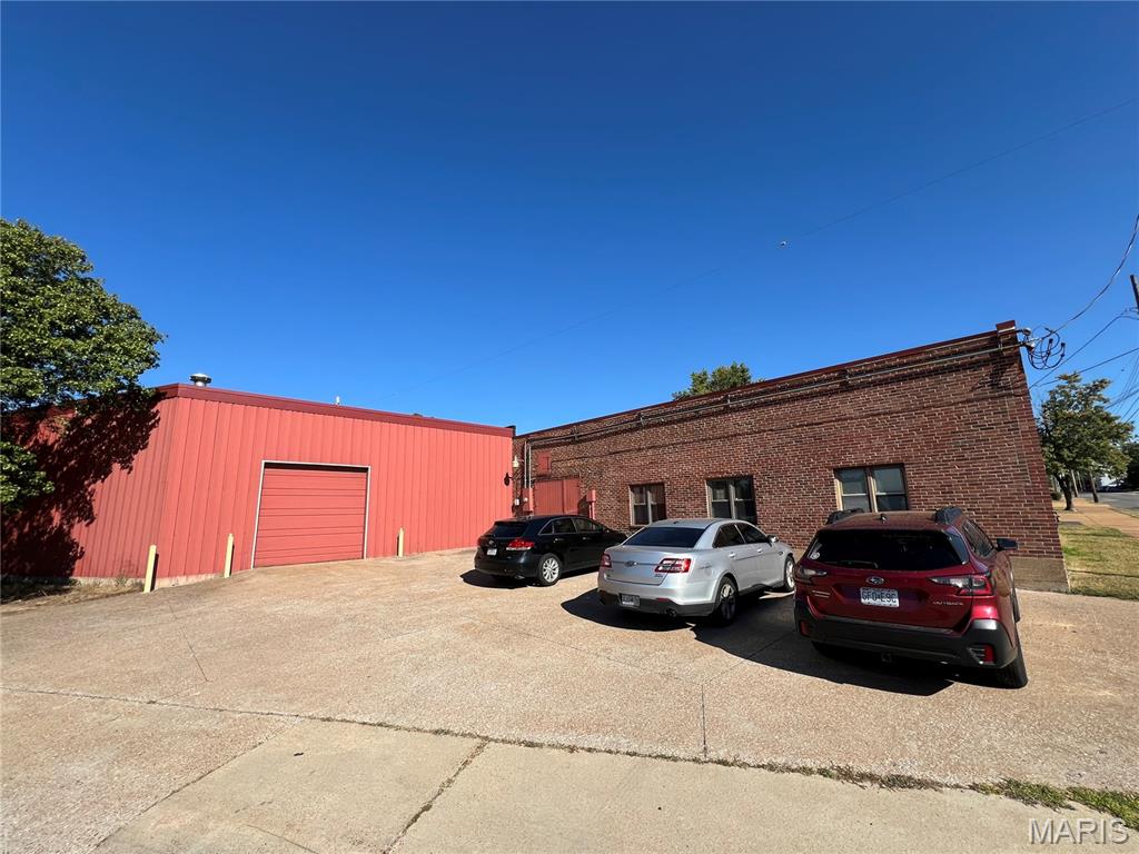 This offering presents an excellent opportunity, featuring a highly functional 19,696 sq ft light industrial building situated on a substantial +/- 43,164 sq ft lot. The building includes integrated office space, which is served by a separate AC unit, while a multi-ton AC unit cools the main building. Operationally, the property is well-equipped with clearance heights ranging from +/- 12 to 20 feet, a three-phase electrical system, and exceptional loading capacity via six grade-level drive-in doors supported by multiple crane bays. Further enhancing utility is a +/- 6,400 sq ft fenced-in yard that includes a canopy roof, an overhead crane bay, and covered access for four of the six drive-in doors. Recent capital improvements include a warranted, double-layer roof installation with a bladder. Given the property's location within the Greenwood Zoning Overlay District (GZOD), this site offers powerful future development potential. The GZOD, which prioritizes a high-quality, pedestrian-oriented, and mixed-use environment, encourages combining light manufacturing with retail and commercial uses.