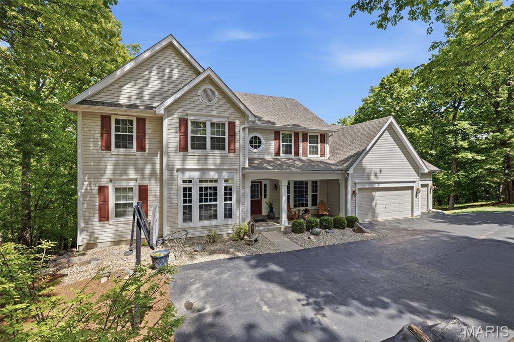 Tucked away on a breathtaking stretch of land this atrium is more than a home! This private retreat is designed for those who want the amenities of the city but privacy of an oasis. 3.26 acres, mature trees, & uninterrupted views create a sense of seclusion that’s increasingly hard to find, yet you’re still minutes from the best of Wildwood. For the nature lover, you will be so close to hiking & mountain biking trails in Greensfelder Park. For winter season slide on over to Hidden Valley Ski Resort just minutes away! 
Inside, the home balances scale & warmth with intention. Sunlight pours through oversized windows, highlighting thoughtfully designed living spaces. Whether you’re hosting a full house or enjoying a quiet morning, every square foot feels purposeful, elevated, & livable. The kitchen anchors the home with both style & function. Built for gathering, entertaining, & everyday ease. 4 upper bedrooms offer privacy & comfort, while the main floor primary suite delivers the kind of space & serenity typically reserved for luxury resorts. This home has storage galore without compromising living space, a 3 car attached garage PLUS a secondary 2 car for all the toys! Think ATV, 4 wheelers, or even your boat! Step outside & imagine evenings on the patio as the sun dips below the tree line, morning spring coffee on the screens in porch, weekends spent exploring your own land, & a level of peace that simply can’t be replicated in more crowded settings. Opportunities like this are rare. Properties like this are remembered. Schedule to see your new home today!