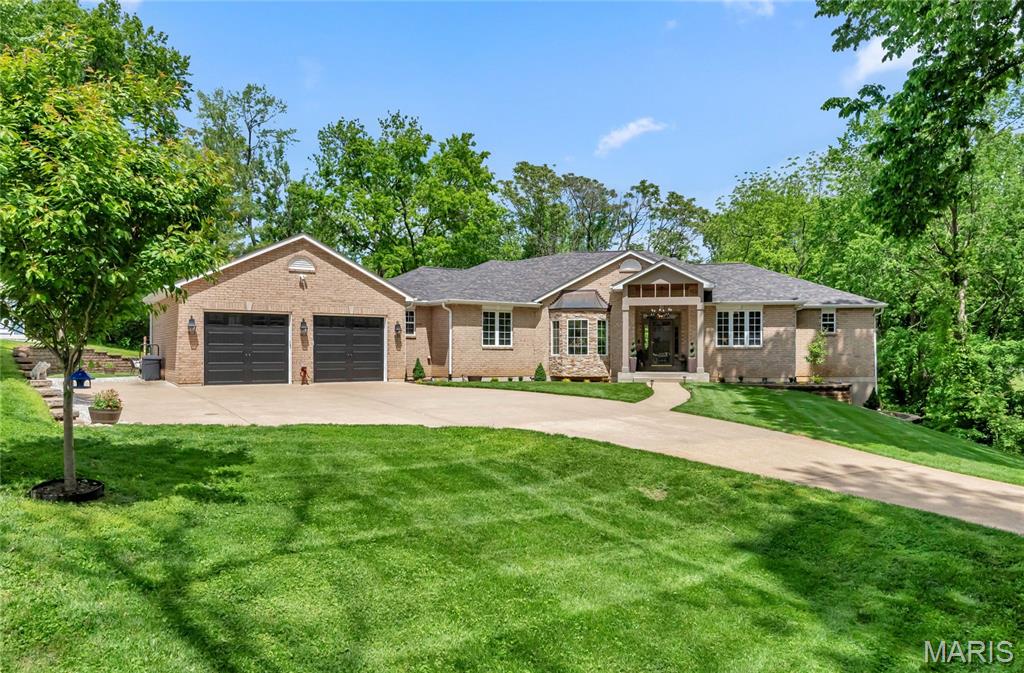 Skip the uncertain costs and lengthy delays of building from scratch! This custom-designed atrium ranch estate offers a rare opportunity to immediately own a property extensively upgraded with ultra-premium finishes typically reserved for brand-new custom construction. This 4,000+ sq ft custom home seamlessly blends sophisticated luxury with everyday functionality. From the grand entry foyer, the home immediately unfolds into a striking, light-filled showcase. The recently renovated kitchen is spectacular! Plentiful cabinetry and granite counters give the chef plenty of room to operate! Oversized (48") upper cabinets have muted glass doors. Large center island with contrasting darker cabinets does double duty as a breakfast bar and wonderful workspace, with useful extras like a built-in icemaker and wine/beverage refrigerator. Full complement of stainless appliances, including a built-in Sub-Zero refrigerator. Extraordinary backsplash with vertically-oriented hexagonal tiles extends from countertop to ceiling! Natural light streams through the window over the sink and is complemented by the recessed LED and pendant lighting. Conveniently adjacent to the kitchen is a wonderfully light, bright, and open breakfast area. The heart of the home is the expansive great room, where hardwood floors are bathed in natural light from the signature atrium windows. A floor-to-ceiling stacked stone gas fireplace with barnwood mantel serves as a stunning focal point, making it a wonderfully inviting space. The sophisticated separate dining room is spacious and light-filled, thanks to the large bay window. Tray ceiling and crown molding add a classic feel to the space, while built-in cabinets and shelving add functionality. For those requiring home office space, this home excels like few others. Start with the separate office off the entry foyer, which includes a copious amount of bookcases and storage cabinets, plus a built-in desktop. No need for a home office? This would make a wonderful library, right down to the rolling library ladder! Retreat to the luxurious main floor master suite. The master bedroom is spacious, light filled, and includes access to a private screened deck - perfect for morning coffee or simply enjoying the private rear yard. Step into the recently updated primary bath and soak in the luxury! Start with heated porcelain tile floors, oversized double bowl vanity with granite counters, private commode, and large walk-in closet. Yet the star here is the oversized 2-person walk-in glass enclosed shower with bench seating and onyx surround - simply amazing! Move to the other end of the main level and find two nicely sized guest bedrooms. Both have recessed areas, while one has a desktop and storage shelving - making for a terrific second office space if needed. A recently updated hall bath is conveniently located just outside the bedrooms, with double bowl solid wood vanity, onyx counter and sink, classic tall wainscoting, and a tub/shower combo with onyx surround. A marvelous laundry room finishes the main level and will make laundry day a treat - thanks to plentiful built-in cabinetry, a newer stainless sink, and a nice view of the front yard. Walk down the extraordinary atrium staircase to one of the largest recreation spaces you will ever find! This versatile space includes areas for billiards (table can stay), a media lounge, and a gaming zone. The highlight is the gorgeous kitchenette/bar, fully equipped with appliances, granite counters, and subway tile. A 4th bedroom is also found in the lower level. It is bright and spacious and includes a built-in desktop. A recently updated full bath completes the finished lower level. Step outside to a sprawling paver patio, perfect for entertaining while taking in the views of your private, picturesque acre-plus lot. Why wait to build? Move into a fully customized luxury estate today. Experience this unparalleled St. Charles property firsthand—schedule your private tour today!