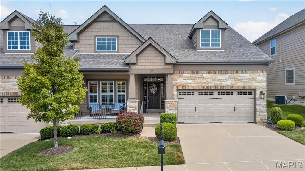 Enjoy the ease of low-maintenance villa living in this beautifully appointed ranch-style home, where thoughtful design, quality finishes, and flexible living spaces come together effortlessly. From the moment you step inside, the welcoming foyer sets the tone with wood flooring, a chandelier, transom detail, and sidelights. The spacious great room creates an inviting gathering space with a gas fireplace, plantation shutters, and a coffered ceiling accented by recessed lighting. The kitchen is equally impressive, featuring custom 42" cabinetry, quartz countertops, a breakfast bar, gas cooktop, and double ovens. The adjacent breakfast room offers a comfortable spot for casual meals and flows naturally with the home's open living spaces. A versatile dining room/study provides the flexibility today's homeowners appreciate. Ideal for a home office, formal dining, or a quiet space to unwind. The main-level primary suite is a true retreat with a coffered ceiling, while the beautifully finished bath offers a tile shower, separate soaking tub, dual vanities, plantation shutters, and a spacious walk-in closet. A second bedroom on the main level also offers a walk-in closet and a full bath. The finished lower level adds even more room to spread out, with a generous rec room, additional bedroom, full bath, recessed lighting, and walk-out access to the patio. Outside, the composite deck and patio extend the living space and provide inviting spots for relaxing or entertaining. Additional highlights include a finished garage, custom landscaping, new HVAC, newer roof, and thoughtful updates throughout. Best of all, the villa lifestyle means less time spent on exterior upkeep and more time enjoying your home, while still offering the space and comfort of a traditional single-family residence. This is low-maintenance living with plenty of room to live, relax, and entertain.