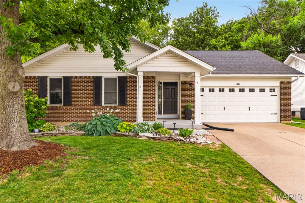 Welcome home to this charming, impeccably maintained residence offering over 1,600 square feet of comfortable living space! Step inside to a stunning vaulted great room featuring rich hardwood flooring, skylights that fill the home with natural light, and a wood burning fireplace. The open-concept layout flows seamlessly into the beautifully updated kitchen complete with white cabinetry, glass-front accents, subway tile backsplash, stainless steel appliances, and a gas range. The spacious vaulted primary suite offers a private, updated bath and a separate glass door shower. Two additional generously sized bedrooms and a full bath with white subway tile complete the main level. The finished lower level provides exceptional additional living space with a large recreation room, laundry area, playroom or den, and abundant storage options.  You will also enjoy the exercise area.  Enjoy outdoor living in the large, private, tree lined level backyard featuring a full 6-foot privacy fence and patio—perfect for entertaining or relaxing. You can rest easy with a newer roof.   Additional updates - just a few years ago, include refreshed bathrooms, modern fixtures, neutral paint tones, new AC coil, furnace, and humidifier, making this home truly move-in ready!