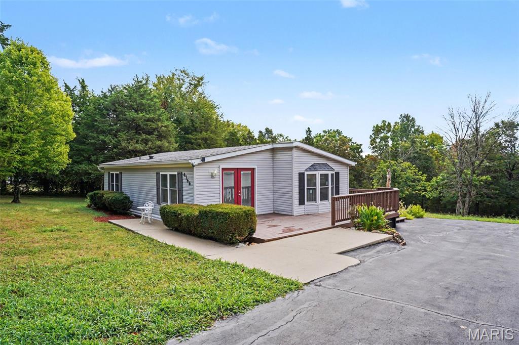Great opportunity for a move-in ready 2 bedroom & 2 full bath ranch home, offering the perfect blend of modern comfort and effortless living, featuring extensive premium upgrades inside and out. On 3.5+ acres with a 5-car garage or workshop and up to 12 parking spaces. From the moment you arrive, you will notice the exceptional curb appeal, highlighted by brand-new front and rear decks finished with fresh stain, and maintenance-free, high-efficiency new Vinyl Kraft thermal-pane windows. Step inside to a bright, open interior showcasing fresh painted with Sherwin-Williams paint, custom wood trim casing on all doors and windows, & new carpeting. The heart of the home is the fully remodeled gorgeous kitchen, beautifully designed with modern custom cabinetry, elegant tile backsplash, a deep-basin sink, and stainless-steel appliances. A clever new refrigerator alcove with a dedicated water line maximizes your cooking workspace. Enjoy you morning coffee on back deck while you watch all the wildlife, you can even have horses. Every room has been thoughtfully updated, from the new ceiling fans and modern lighting fixtures, as well as brand-new smoke alarms. The restful primary suite serves as a private retreat, complete with a custom built walk-in closet & a luxury master bath with space-saving pocket door. This home is an absolute must see! Step outside to appreciate the great landscaping, privacy in backing to woods, and the great opportunity for gatherings by the bonfire circle.  HOA annual fee is $120.00 annually