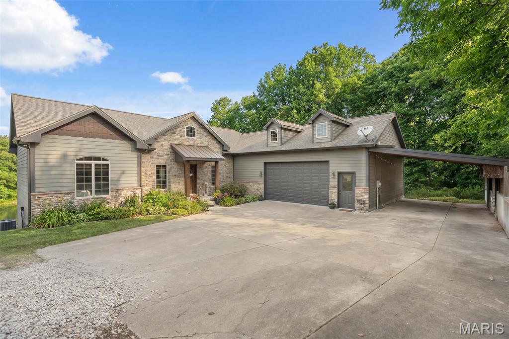 This DELIGHTFUL ranch home features 3 bedroom, 3.5 bathrooms all nestled privately on 5.5 acres gently rolling. For fishing enthusiasts, there is a large pond with blue gill, bass or catfish right in your own back yard. The rustic farm-like interior offers on the main level an inviting open floor concept design with kitchen, living room & nook area adorned with wood design ceramic tile floor, impressive 10-foot ceilings, some solid elder wood doors and also allowing for ample of natural light. A welcoming living room, the kitchen boast with breakfast bar, center island with seating, granite countertops, & backsplash. A warm breakfast nook, that leads outside to an expansion deck that is partially covered, overlooking the gorgeous backyard with the pond, great for enjoying the serene sounds of nature, watching the sunset, or relaxation. From the breakfast area, flowing effortlessly through a charming barn door, into a formal dining room complete with coffee bar and a wood-burning stove, creating a cozy atmosphere for those cold winter days. An elegant primary suite with a walk-in closet, dual sink, and tile shower. Additional bedroom with walk-in closet. Full bath. Access to the walk-out lower level is provided by two staircases, leading to a complete living paradise with wet bar, sizable family room, bedroom, bonus room, 2 laundry areas, 1.5 baths and plenty of storage. A nice covered patio, great for entertaining. Oversized 2-car garage with attached carport. The construction of the home is highlighted by Diamond Kote siding, very durable & aesthetic appeal. Don't miss out on viewing this Country Setting Property, No restrictions, No HOA, Easy Access to l-44, Washington School District, Call today!