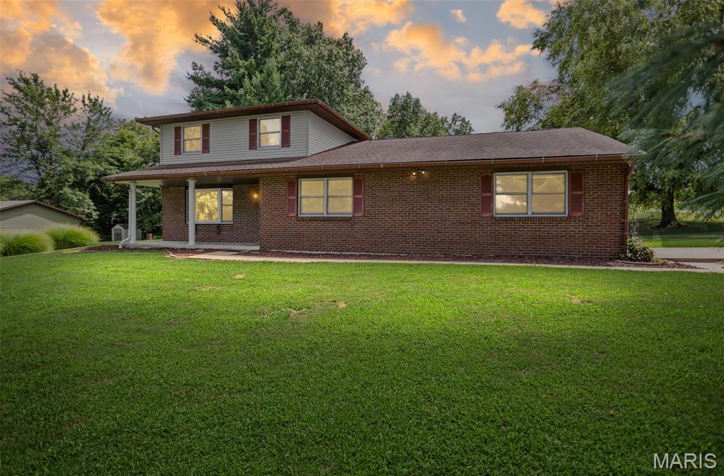 Welcome home to Spring Valley Estates! Nestled on a level corner lot of just over a half acre in one of Grafton's most desirable neighborhoods, this beautifully updated tri-level home offers the perfect blend of space, comfort, and functionality. Featuring 4 bedrooms, 2.5 bathrooms, and an attached 2-car garage, this home has been refreshed with brand-new flooring throughout and fresh paint, making it truly move-in ready. The inviting main-level living room features a cozy wood-burning fireplace, while the spacious upper-level family room provides additional living space perfect for entertaining, relaxing, or a playroom. The thoughtfully designed layout includes a convenient half bath on the main level, with three bedrooms on the upper level, including a spacious primary suite with its own private bath. An additional bedroom offers flexibility for guests, a home office, or hobbies. The sunroom, added in 2019, provides the perfect place to enjoy your morning coffee or unwind while overlooking the peaceful backyard. The unfinished basement offers excellent storage or the opportunity to create additional finished living space to suit your needs. The flat, oversized yard provides plenty of room for outdoor entertaining, gardening, play, or simply enjoying the peaceful surroundings. Located in the highly sought-after Spring Valley Estates subdivision, you'll appreciate the quiet setting while enjoying access to the community's Spring Valley Lake. If you're looking for an updated home with generous living space, a spacious yard, and a beautiful neighborhood, this is one you won't want to miss!