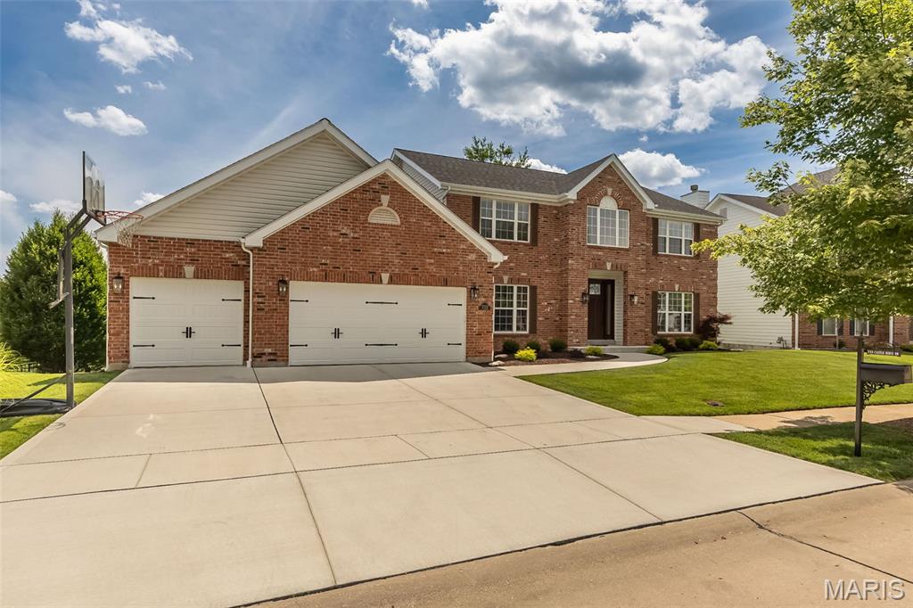 Sweeping views and an exceptional setting create the backdrop for this beautifully maintained 4-bedroom, 3.5-bath two-story offering over 3,000 sq ft above grade plus a beautifully finished walk-out lower level. Perfectly positioned on a premium cul de sac lot, this exceptional home combines timeless elegance with thoughtful updates and outstanding indoor and outdoor living spaces. A full brick front, newer driveway and sidewalk, manicured landscaping, and an impressive two-story foyer with rich hardwood floors and a grand T-staircase create an unforgettable first impression.

The center hall floorplan offers formal living and dining rooms, while the spacious family room features a brick fireplace, stunning bay window and seamless flow into the beautifully updated kitchen. Designed for both everyday living and entertaining, the kitchen boasts abundant cabinetry, granite countertops, an oversized center island with a breakfast bar, stainless appliances, a planning desk, a walk-in pantry and a bright breakfast area with access to the deck.

Upstairs, a cozy sitting area overlooking the foyer welcomes you to the impressive primary retreat. Double doors open to a spacious suite highlighted by soaring cathedral ceilings and dual walk-in closets. The primary bath features vaulted ceilings, an oversized double vanity, a corner soaking tub, and a separate shower, creating a private escape.

The finished walk-out lower level offers incredible flexibility with expansive recreation and entertaining spaces, fitness room and direct access to the paver patio. Outdoor living is equally impressive with two decks, double French door access, incredible panoramic wooded views and an irrigation system that helps keep the grounds beautifully maintained. Residents also enjoy neighborhood pool and clubhouse amenities, adding to the exceptional lifestyle this community offers.

Major improvements include a newer roof, Trane HVAC system, remodeled primary bath, full bath addition in lower level, garage doors, custom entry door, kitchen flooring, composite deck, driveway, sidewalk, exterior lighting and refreshed landscaping. Sellers have already completed the Ballwin occupancy inspection for added peace of mind. An exceptional opportunity to own a home where the views are as memorable as the craftsmanship and care behind them!