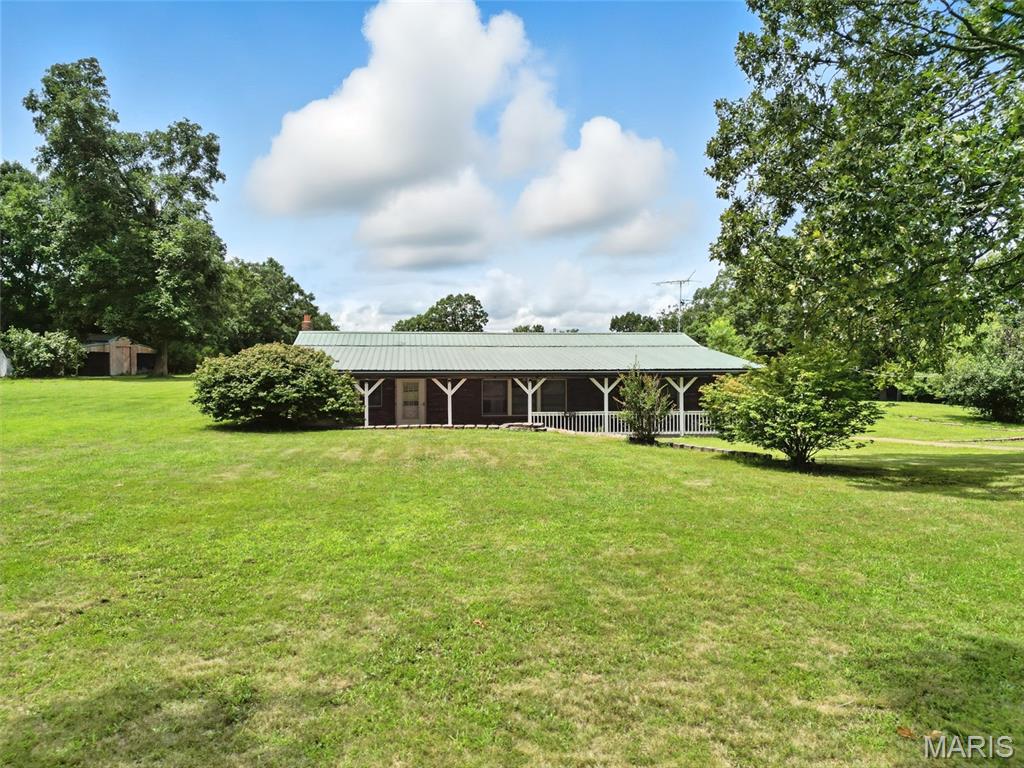 Don’t miss the chance to own this unique earth home nestled on just over 3 acres in a prime spot right off Hwy 8. Inside, you’ll find an inviting kitchen and dining area, a spacious utility room, a comfortable primary suite, and an open living area ideal for gathering with family and friends. Enjoy lower energy bills with both gas and wood-burning heating options. Spend peaceful evenings on the covered front porch, surrounded by the tranquility of your own land. Outdoors, you’ll love the pear and apple trees and the flexibility the outbuilding offers — perfect for storage, hobbies, or even a small business. There’s plenty of room for vehicles and projects with a two-car covered carport and an oversized shop/garage featuring electricity, multiple garage doors for easy access, and a charming cedar room. This property is being sold as-is, offering you the opportunity to add your personal touch. Experience country living with all the practical features you need — schedule your showing today!