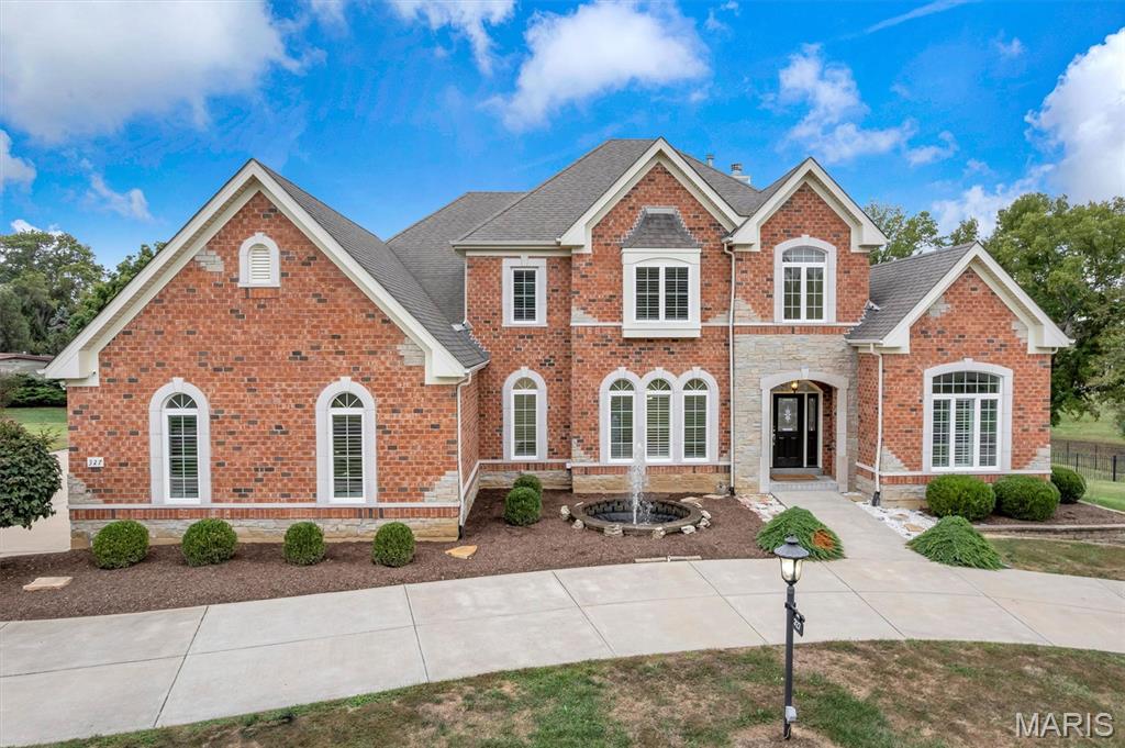 Step into timeless elegance with this French Provincial masterpiece nestled on 1.35 acres in the heart of Creve Coeur. Offering 5 bedrooms, 5.5 bathrooms, and nearly 6,000 square feet of living space, this home combines classic architectural charm with modern luxury.

A circular drive with a central fountain welcomes you to the stately brick facade accented with stone detailing, arched windows, and architectural symmetry that exudes curb appeal both day and night.

Inside, you’ll find soaring ceilings, abundant natural light, and plantation shutters throughout. The chef’s kitchen features a Wolf gas cooktop, stainless steel appliances, a butler’s pantry, and seamless flow into the breakfast and family rooms—perfect for entertaining or casual gatherings. Additional highlights include a three-car garage with a Tesla charger, separate dining room, and a beautifully designed exterior fountain.

Each of the five spacious bedrooms offers its own private full bath, ensuring comfort and privacy for every family member or guest. The primary suite provides a serene retreat with spa-like finishes, while the finished lower level adds versatile living space for recreation, fitness, or media.

Enjoy the outdoors on the flat, fenced 1.35-acre lot—a rare find in this sought-after neighborhood—ideal for play, pets, or a future pool.

Centrally located in Creve Coeur, this home delivers sophistication in the beautiful, quiet BelleCoeur neighborhood.