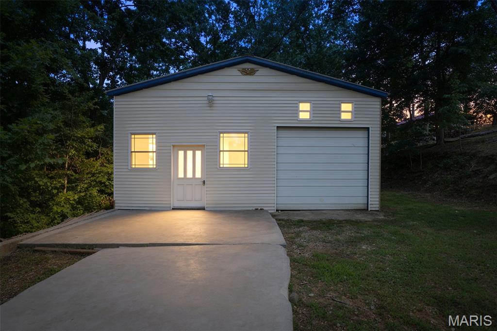 Are you Ready to spend the summer at your new Lake Lot?? Now is your chance! Featuring 2 Lots with a 580 sqft finished building with electricity and an insulated garage attached. Perfect spot to store your boat or any side by sides and toys. There is One bedroom, One bathroom and an oversized loft that can be used as well. Stay warm in the winter with the wood burning stove and AC is provided through a window unit. The 2nd Lot has a storage shed on it for all of your extra items. If you are looking for your own private retreat that is approximately an hour from St Louis area, you have found it!